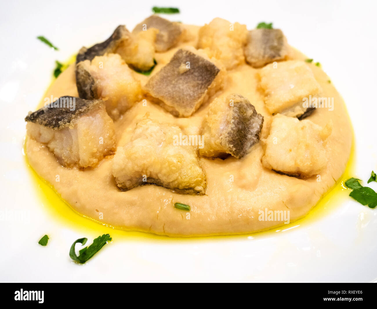 Italian cuisine pieces of Baccala (salt cod) with cream of chickpeas