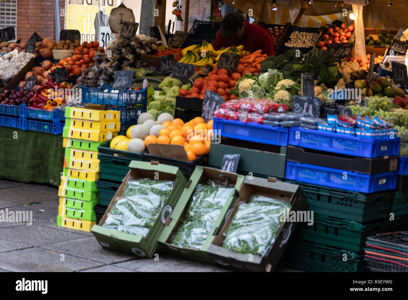 Man Working at traditional British Fruit and Veg stall Stock Photo