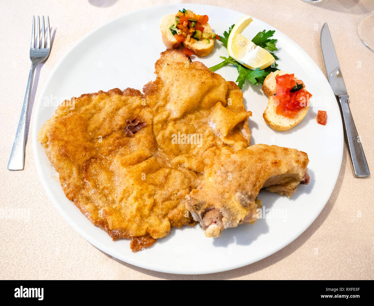 Italian cuisine top view of Cotoletta alla Milanese (panfried