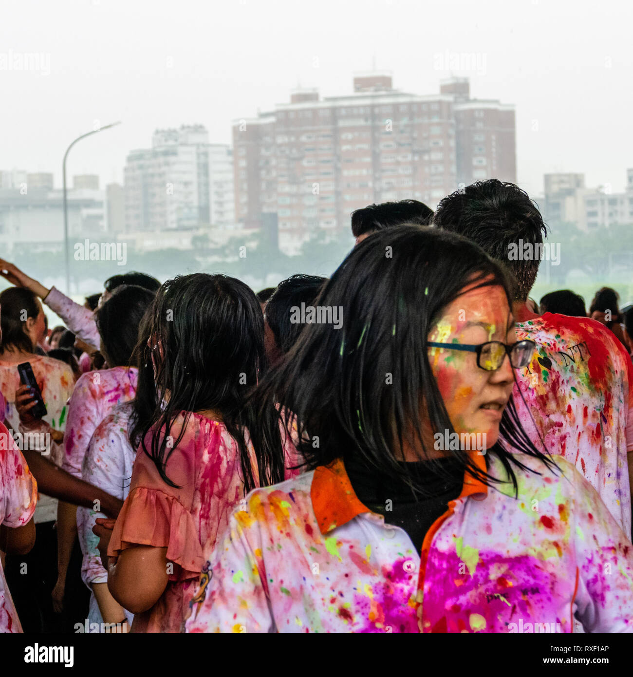 TAIPEI, TAIWAN - MARCH 9, 2019: Happy people dancing and celebrating Holi festival of colors Stock Photo