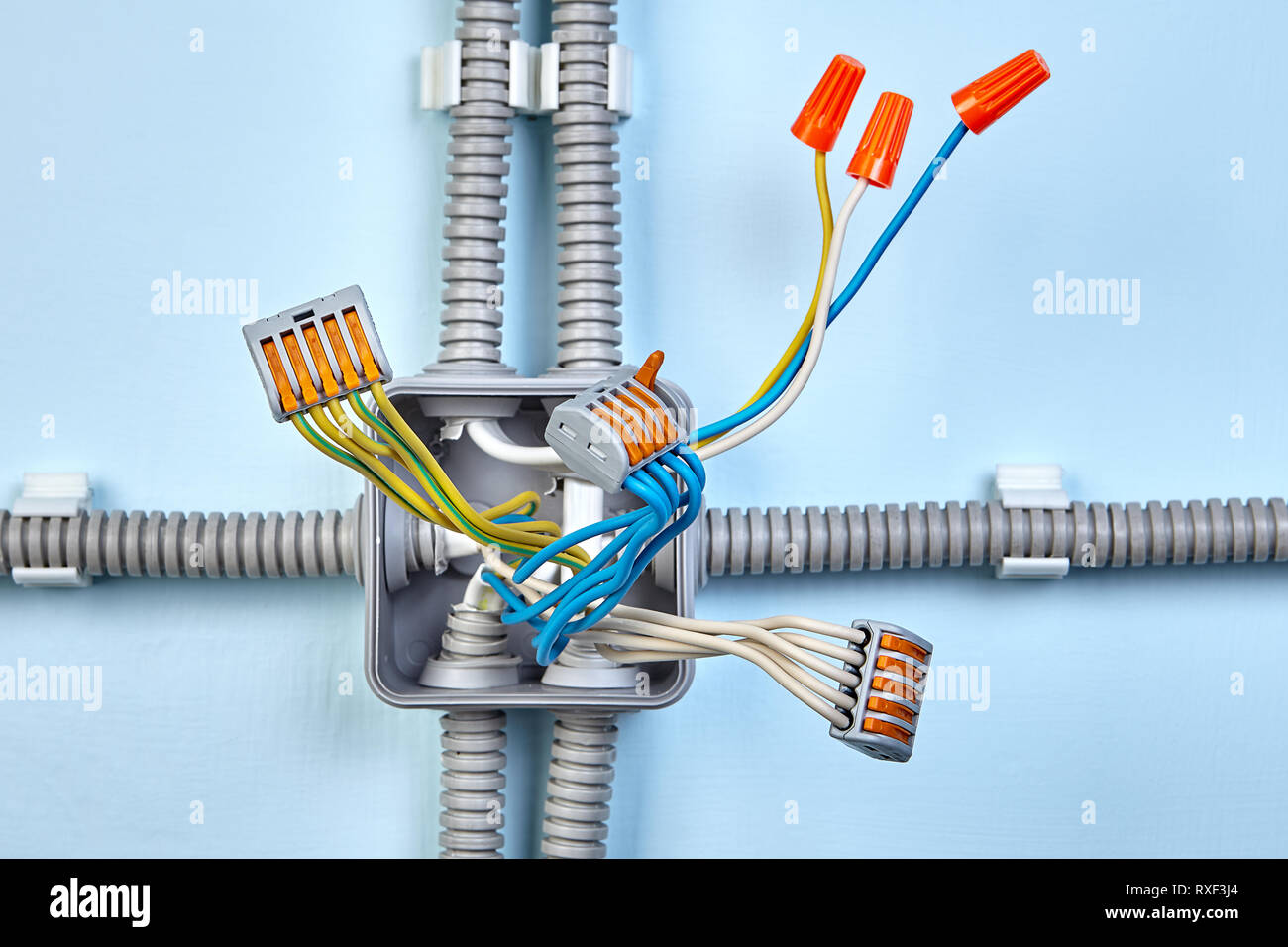 Process of mounting electrical junction box with help of twist splice wire connectors and push wire connector. Stock Photo