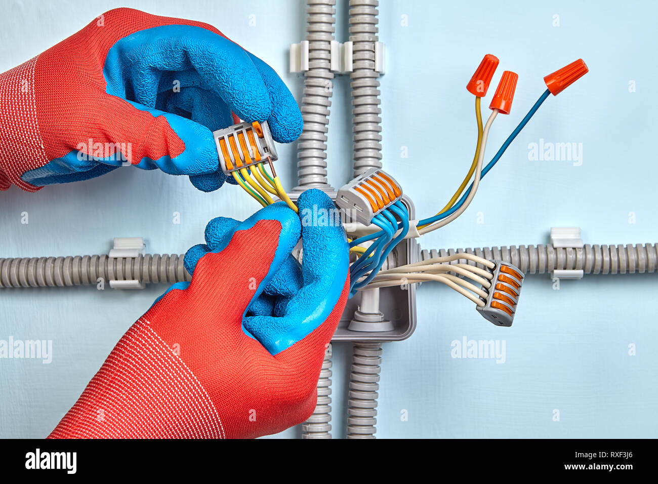 Electrician is mounting electrical junction box with twist splice wire