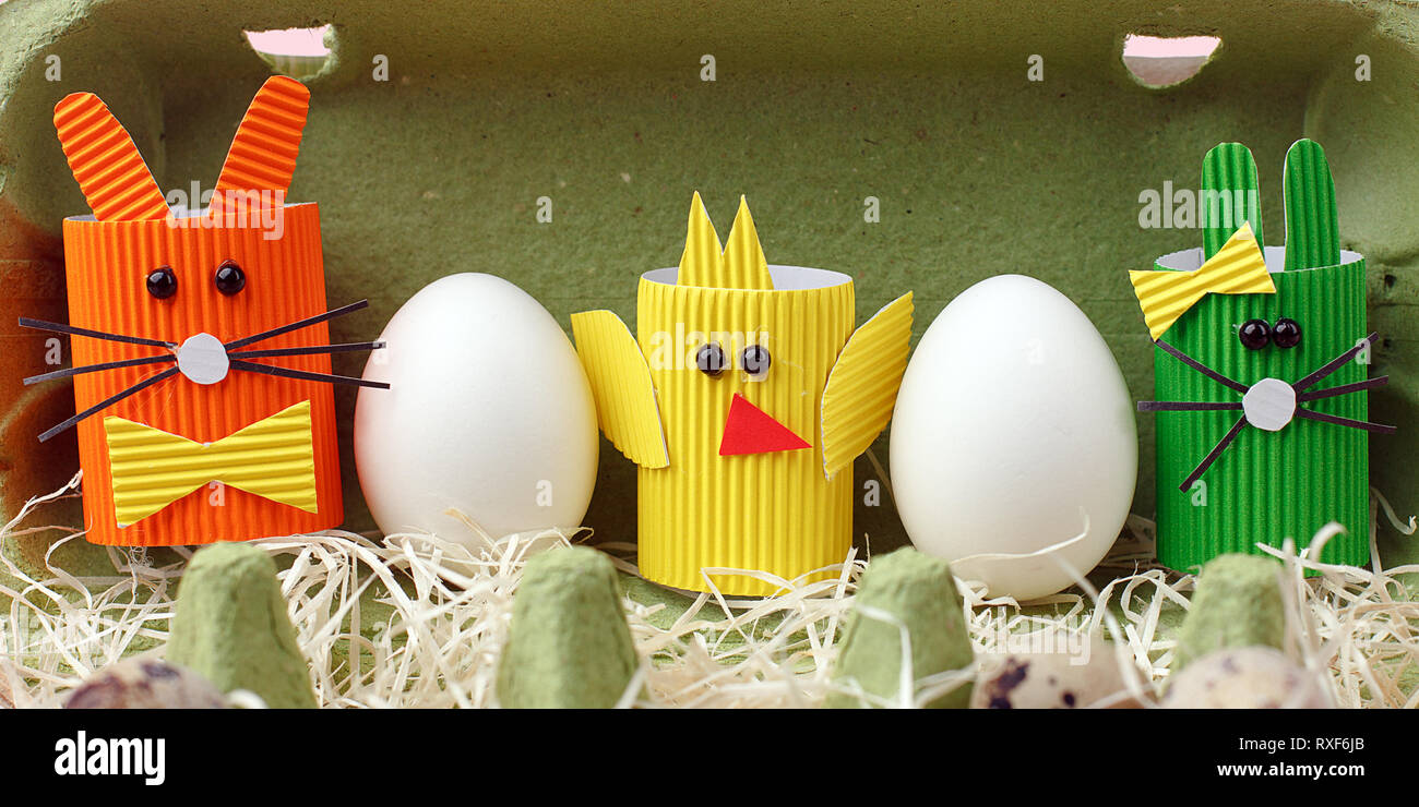 Easter spring decorative composition with homemade easter paper craft funny rabbit, chickens and quail eggs .Holiday celebration decorations. Stock Photo