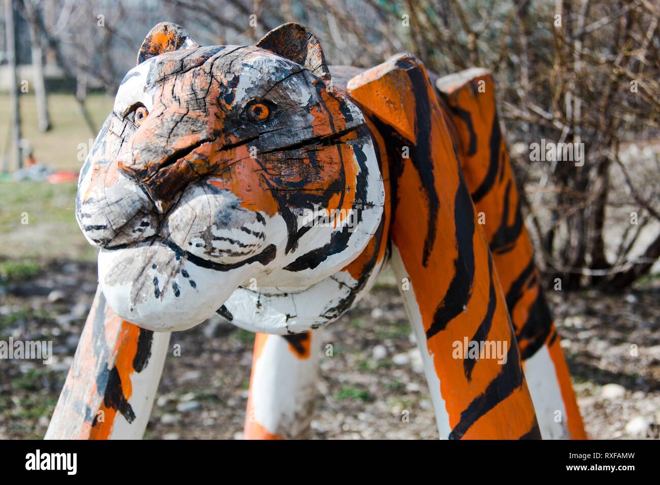 Statue of tiger from wood in detail. Painted as real tiger. Big toy for