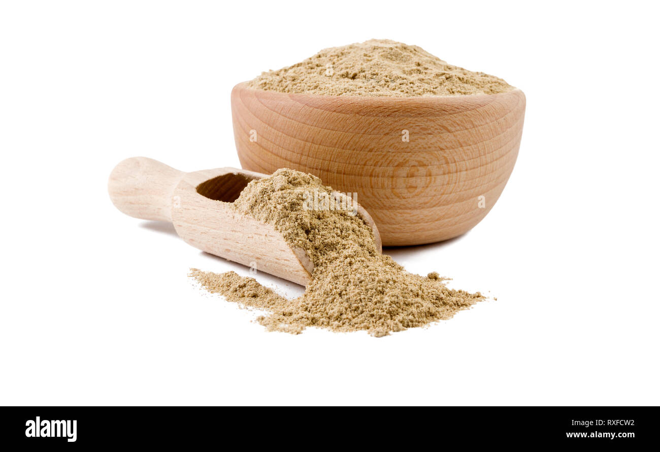 cardamon powder in wooden bowl and scoop isolated on white background. Spices and food ingredients. Stock Photo