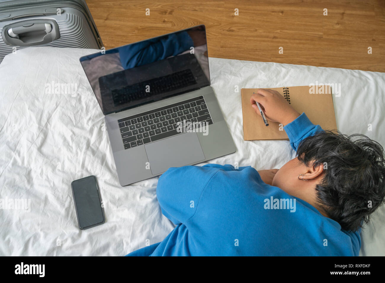 Top view of exhausted Asian woman sleeping on bed Stock Photo