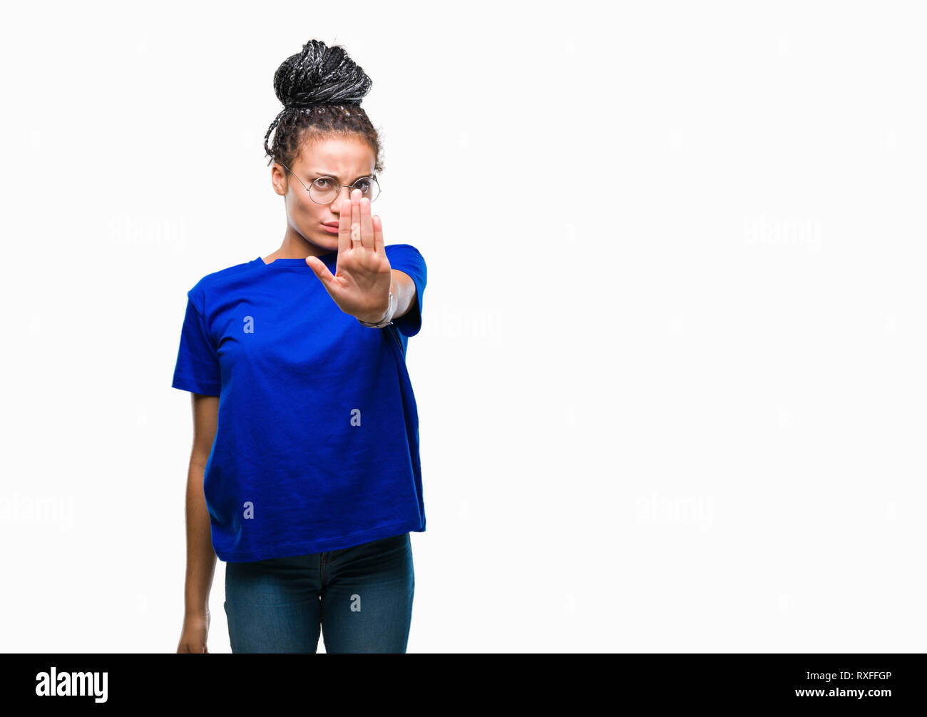 Young braided hair african american girl wearing glasses over isolated background doing stop sing with palm of the hand. Warning expression with negat Stock Photo