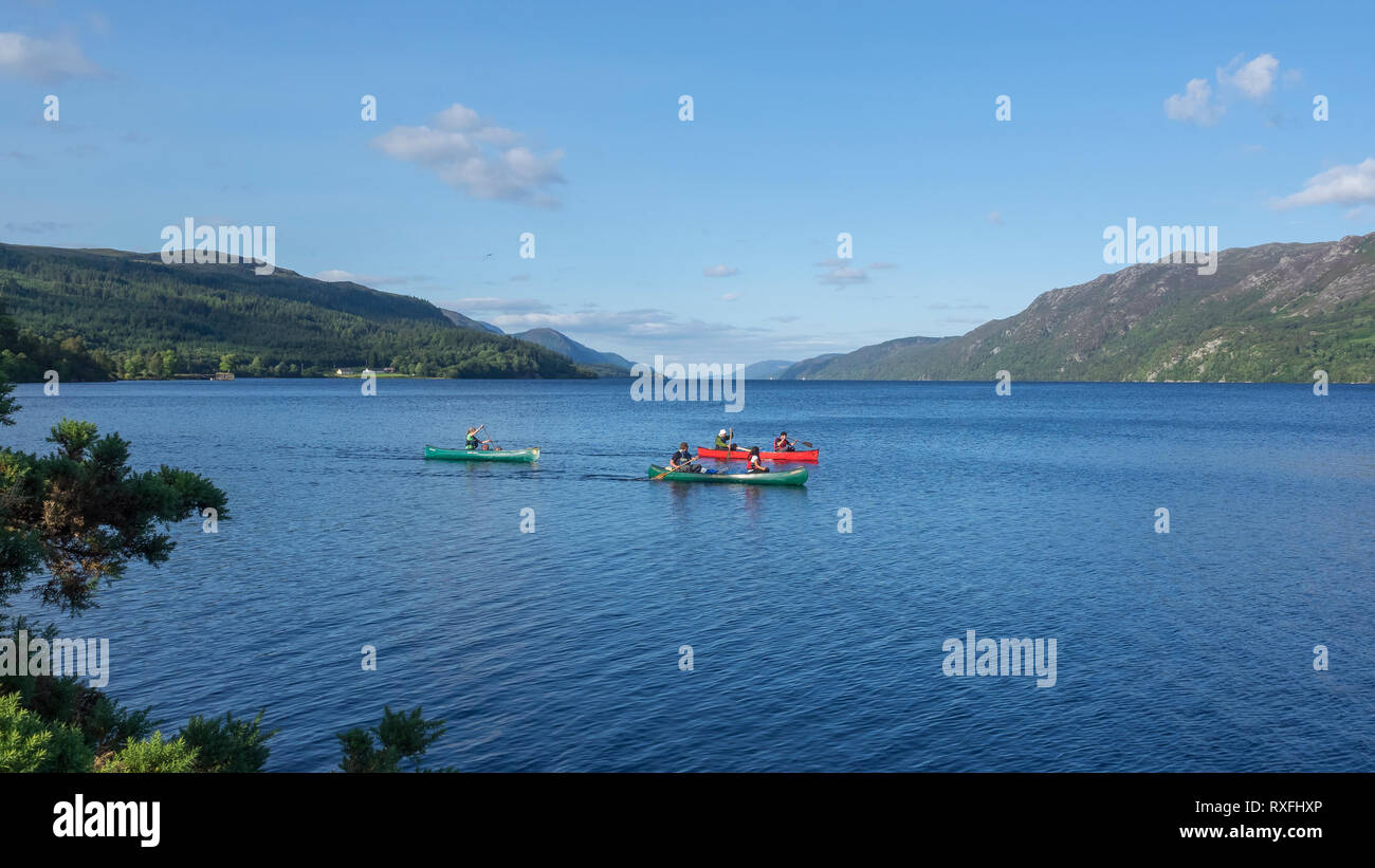 Five people canoeing in three canoes on Loch Ness near Fort Augustus, Highland Region, Scotland Stock Photo