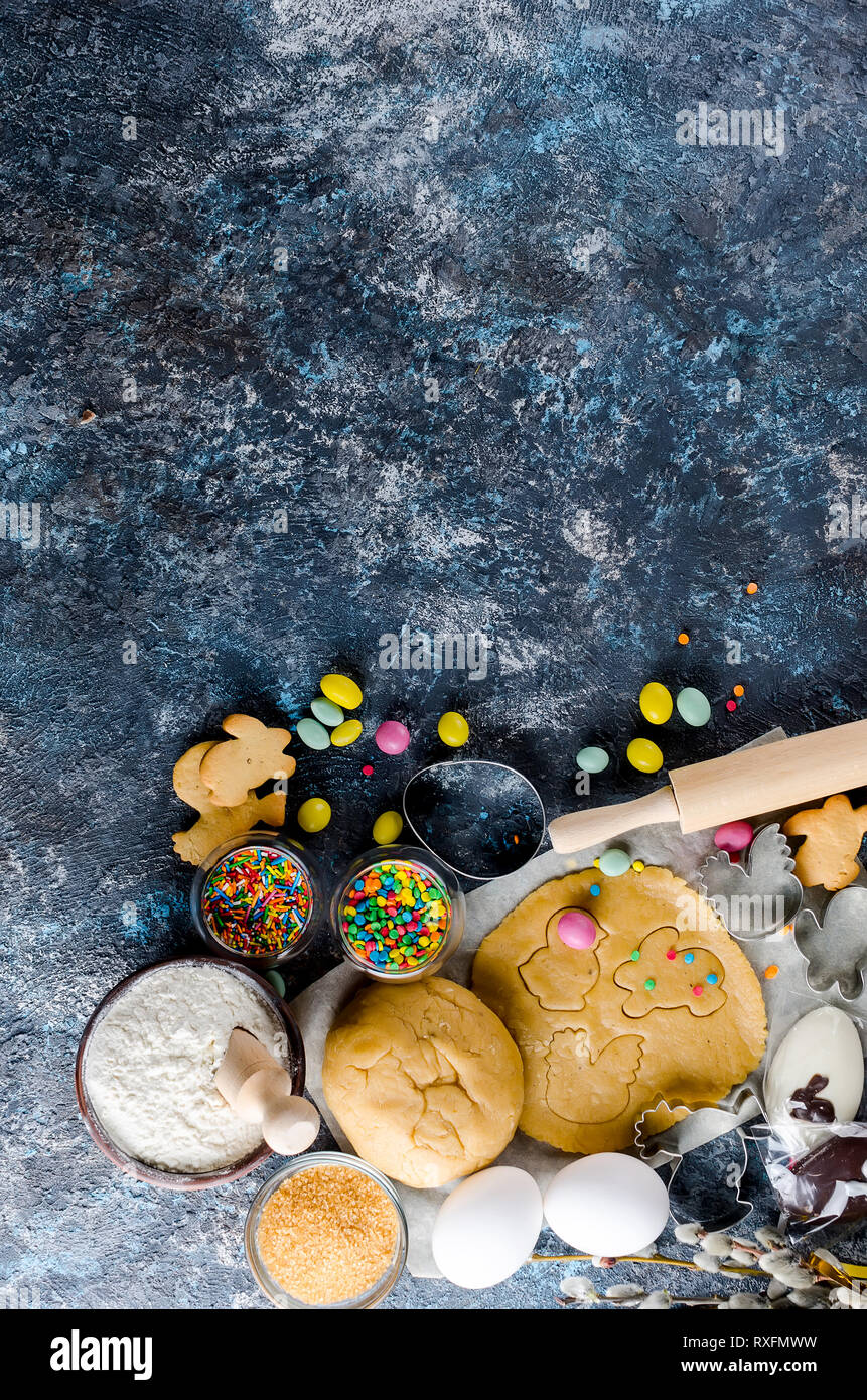 Happy Easter card. Easter biscuits,  cuttings, candy eggs and ingredients for baking rolled dough dough Stock Photo