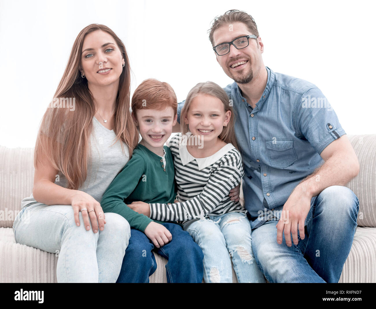 happy family sitting on the couch in the living room Stock Photo - Alamy