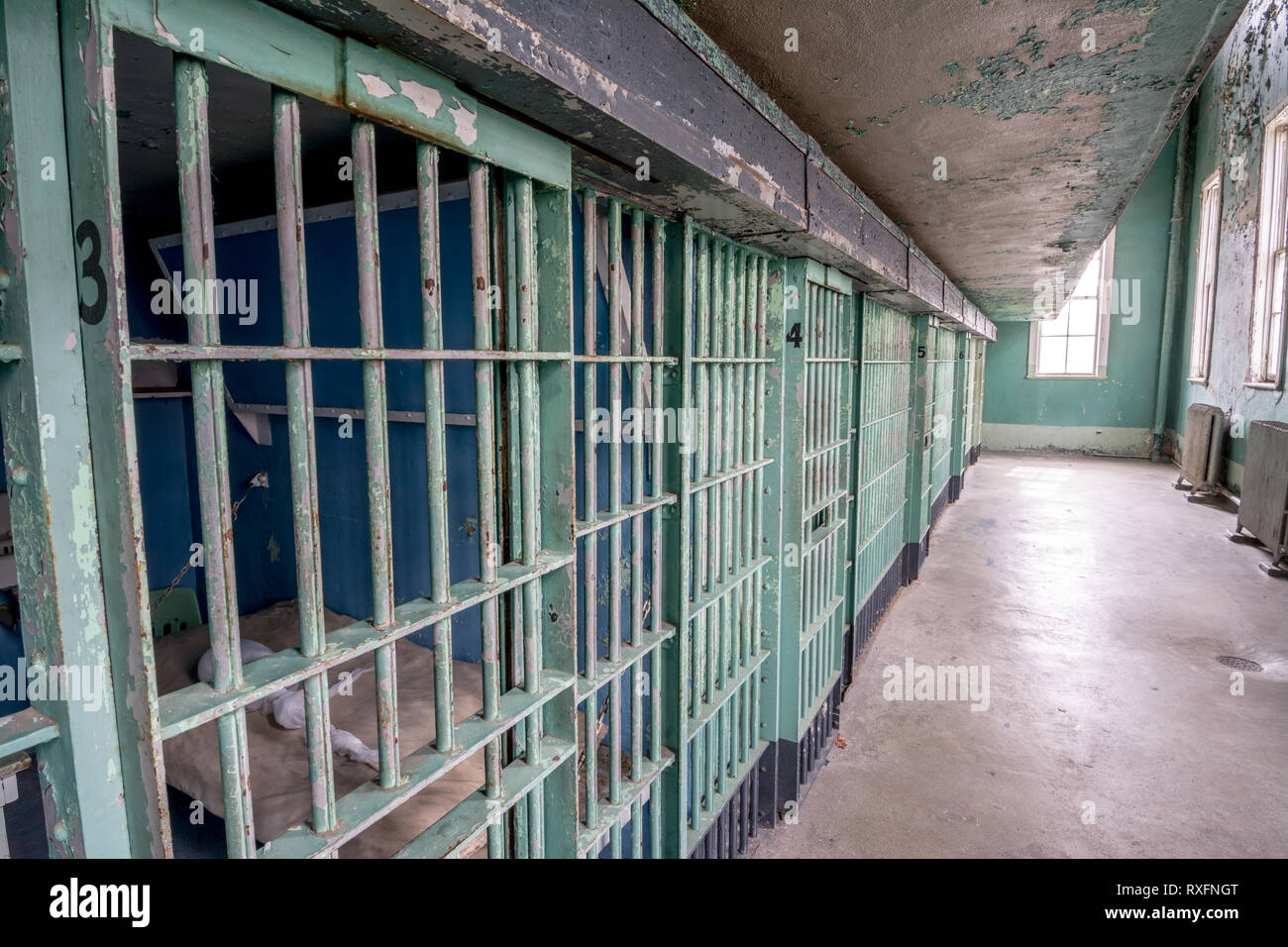 Prison cell block of jail doors with steel bars Stock Photo