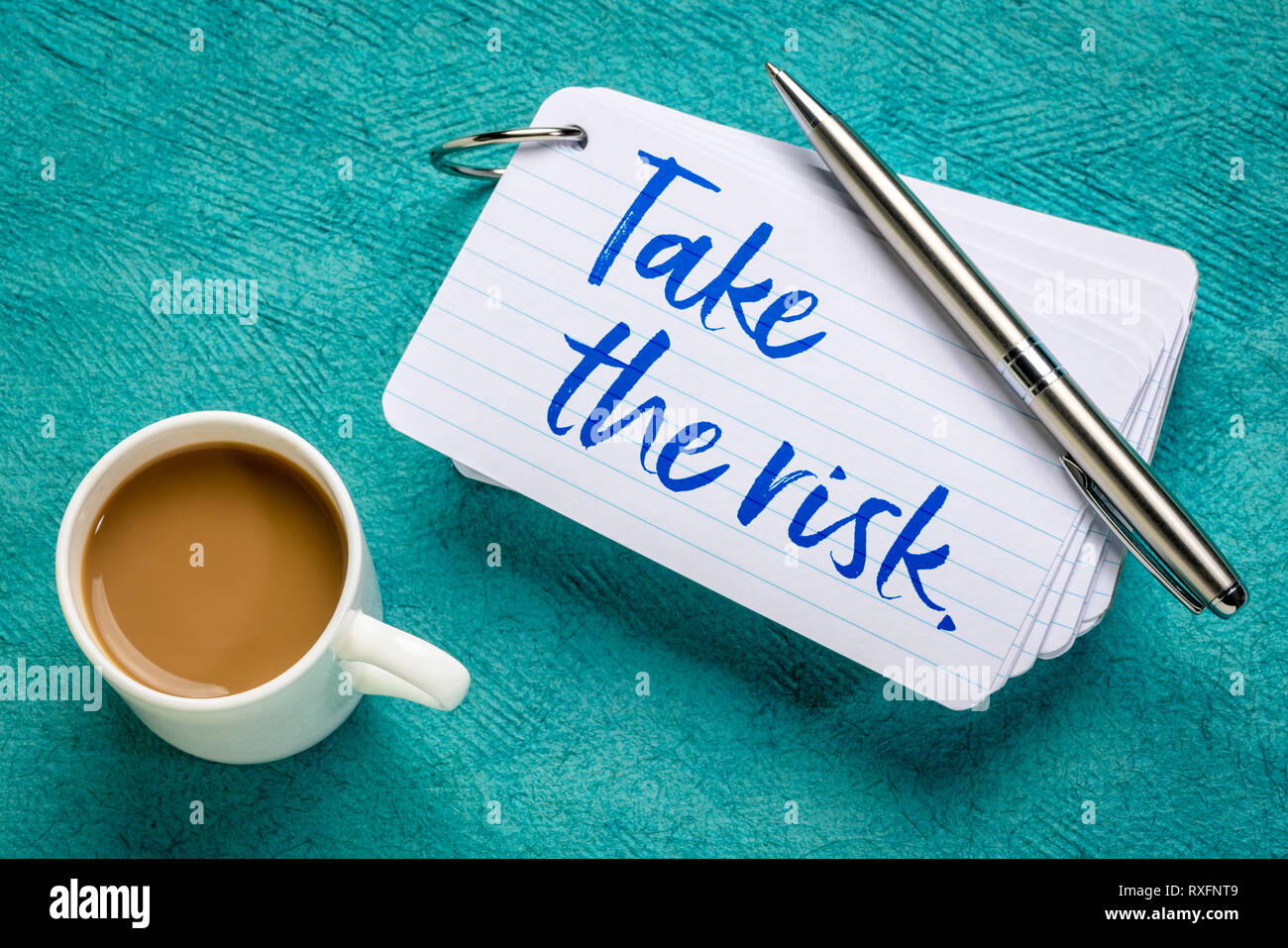 Take the risk - reminder on a stack of  index cards with a cup of coffee Stock Photo