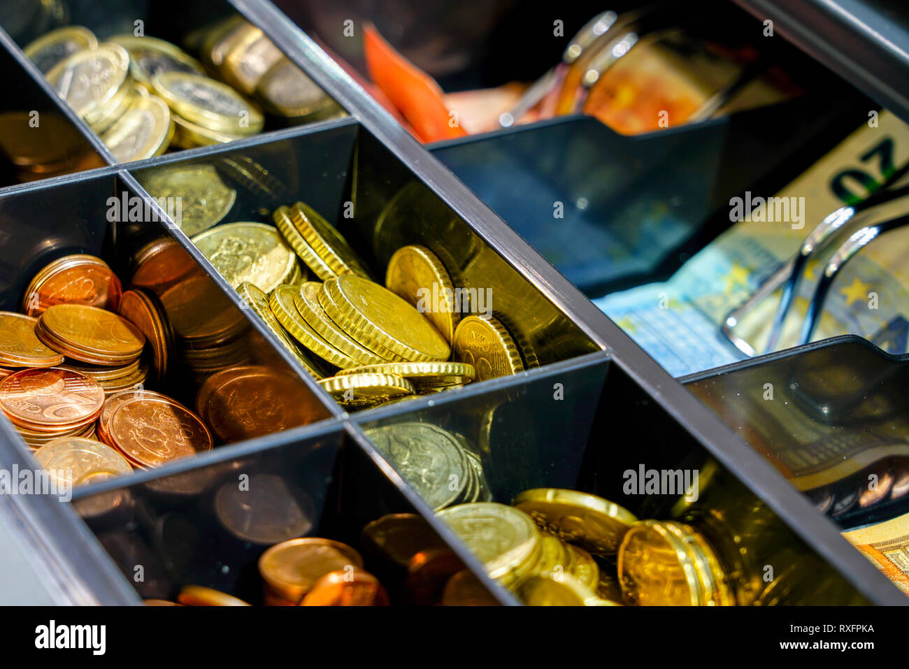 Open cash register drawer closeup with lot of coins and banknote Stock Photo Alamy