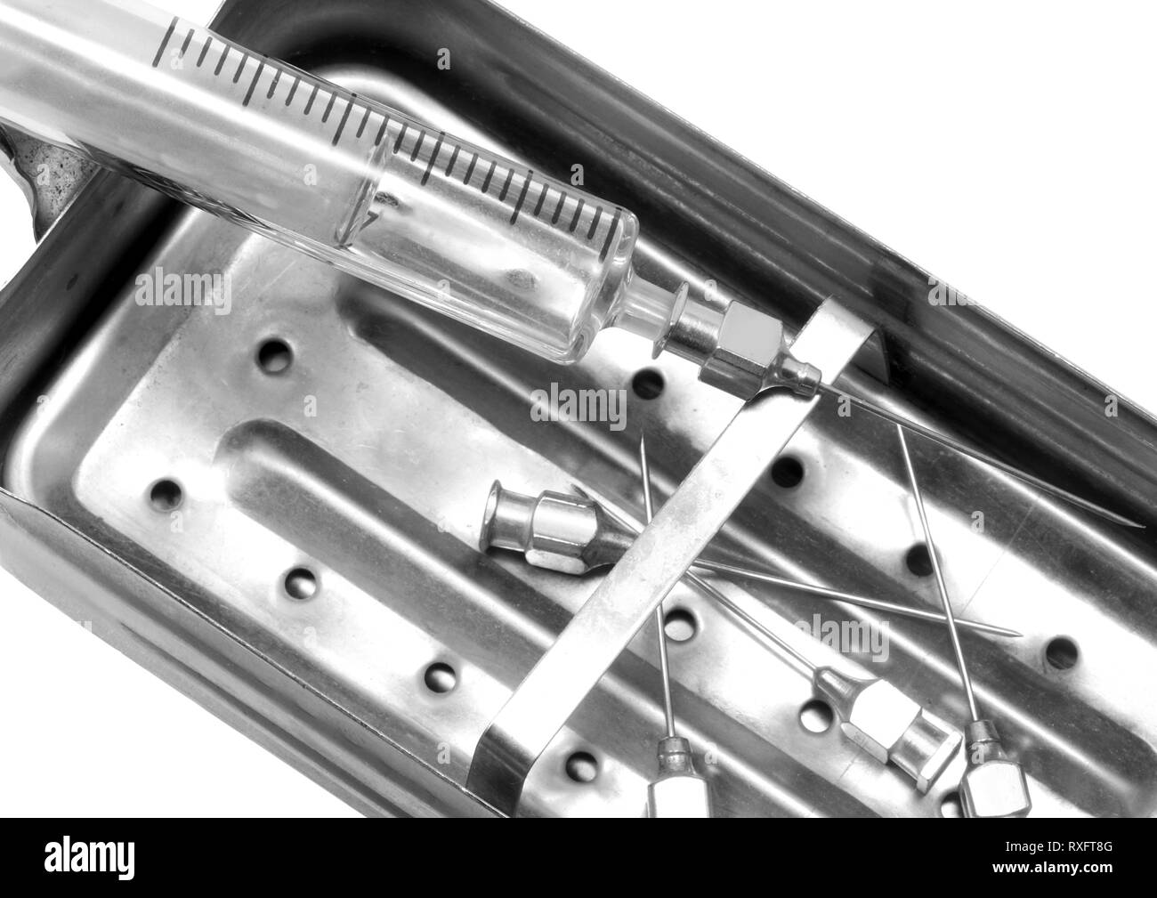 steel container that was once boiled to  sterilize the very old glass syringe and steel needles Stock Photo