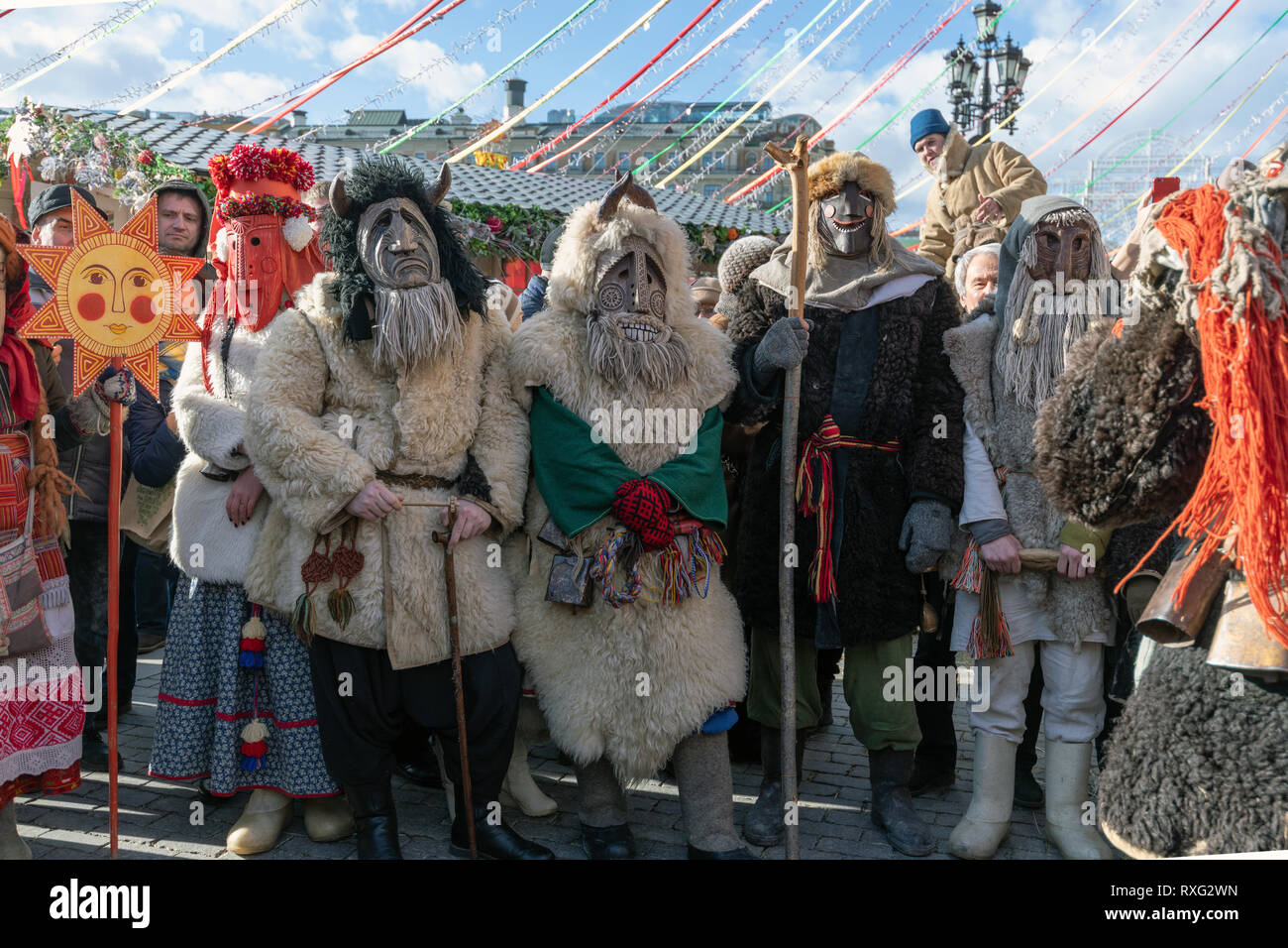Moscow, Russia - March 9. 2019. Masked men during celebration of Shrovetide on Manezh Square Stock Photo