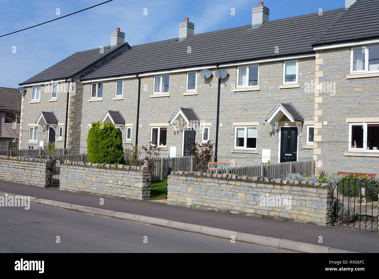 March 2019 Row of new terraced homes built in local stone, in the