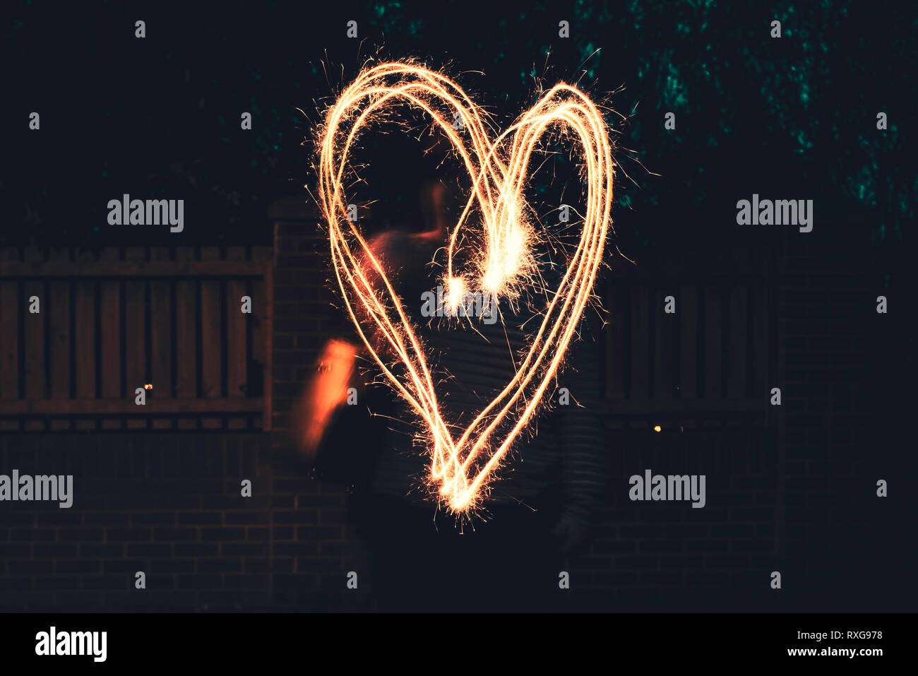 A large heart drawn out with a sparkler Stock Photo