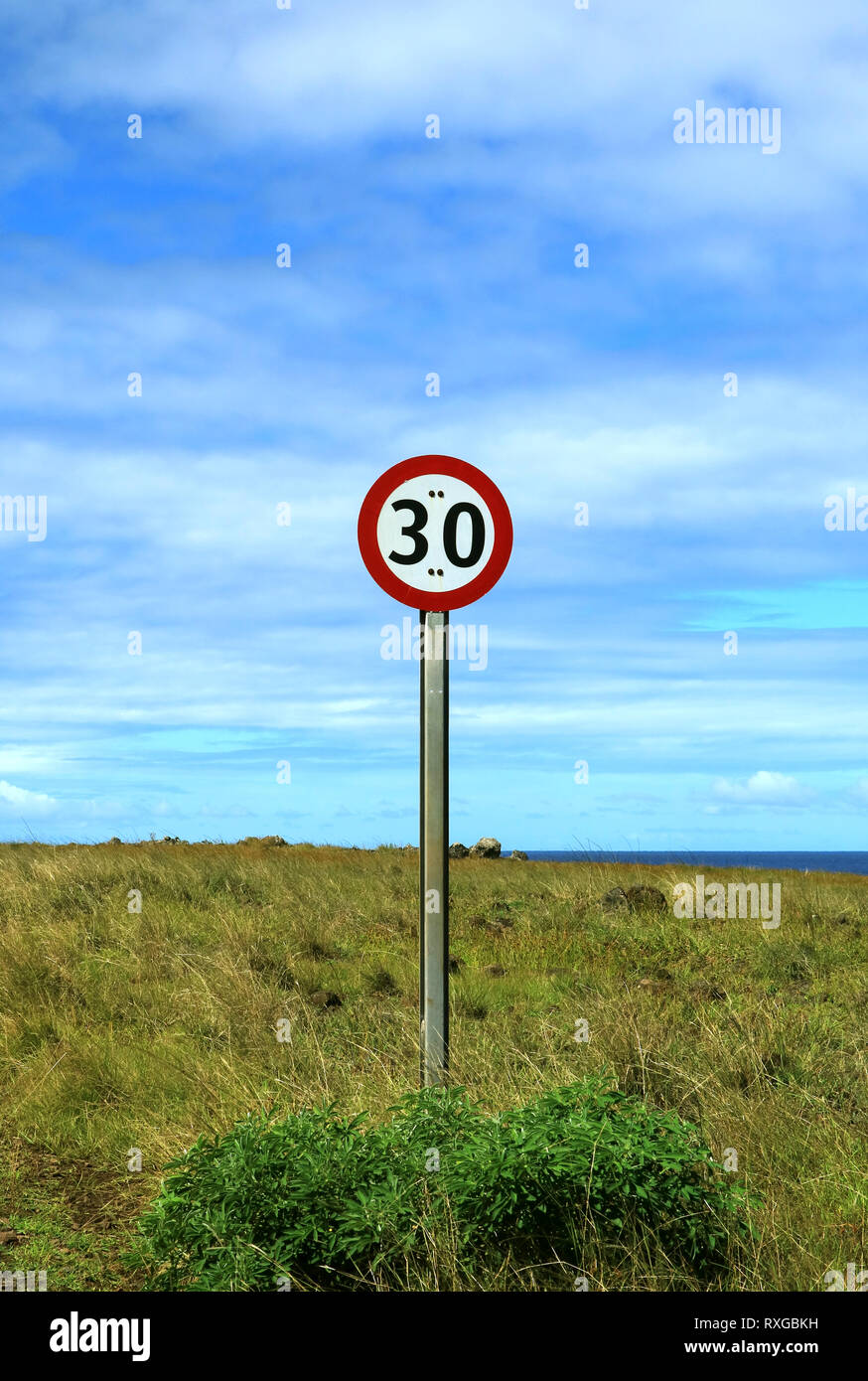 Vertical image of speed limit signpost on the roadside of Easter Island