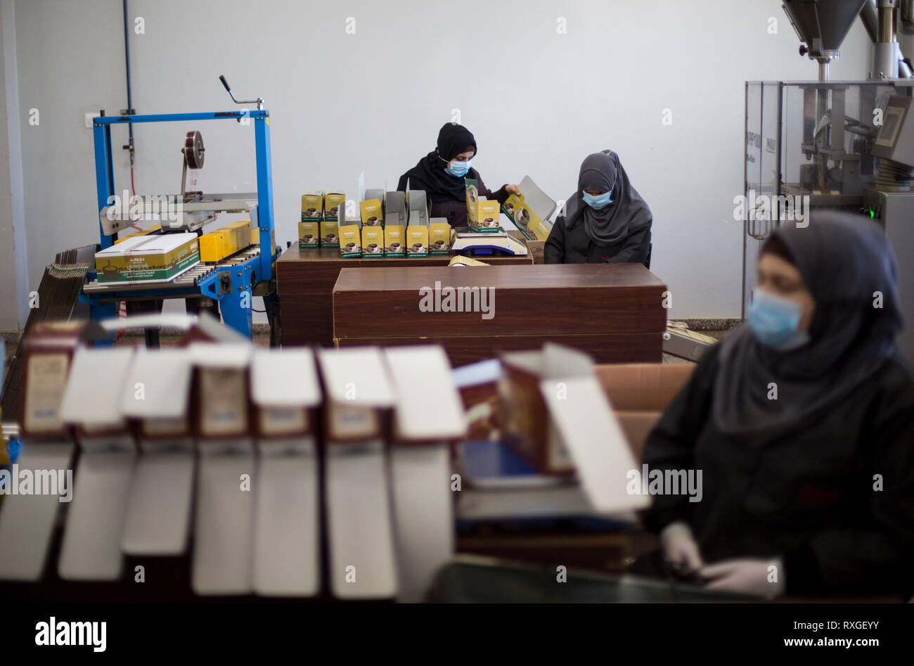 Palestinian women are seen working at a coffee factory in the northern Gaza Strip after the International Women's Day celebrations on 8 March. Stock Photo