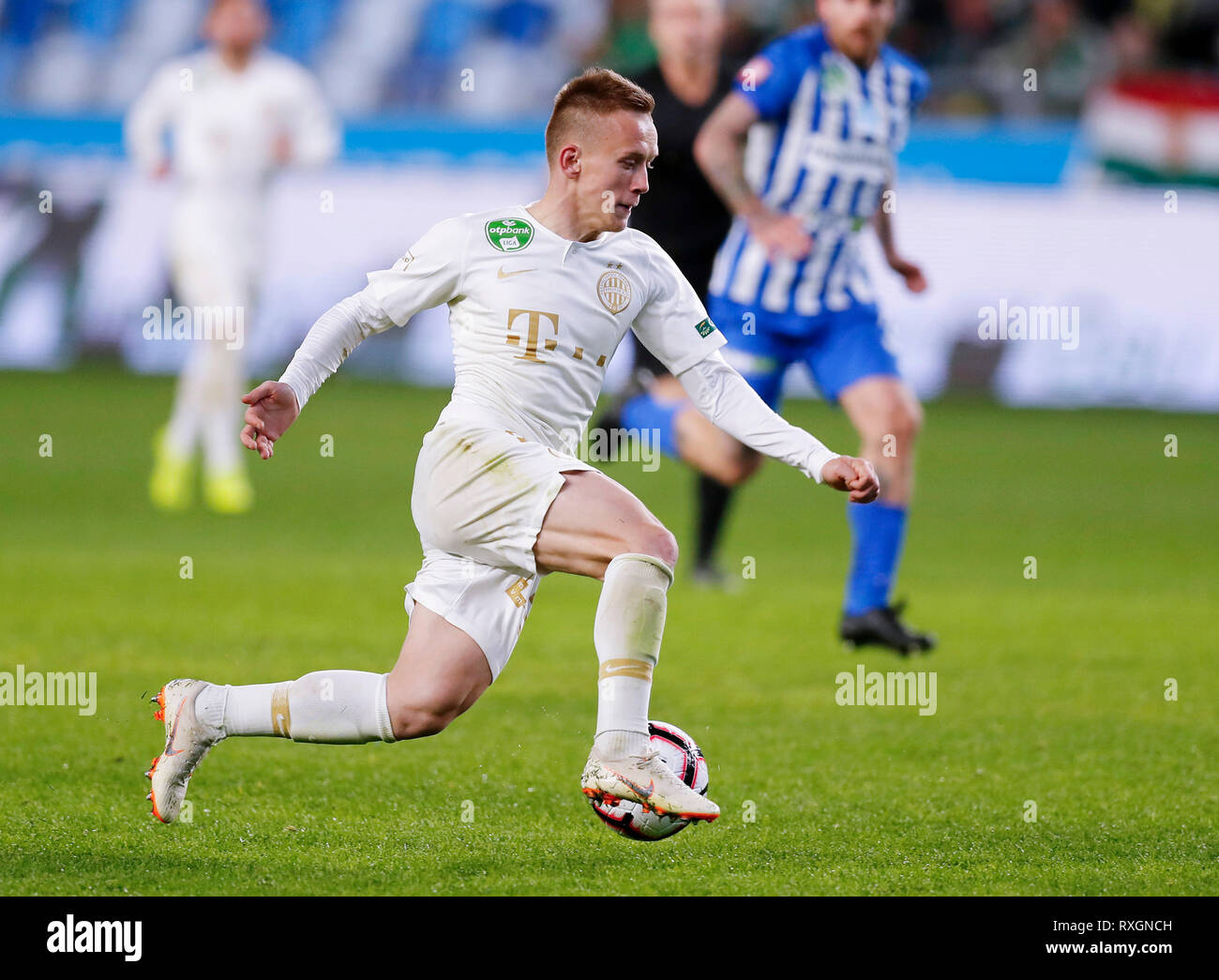 Ivan Petryak of MOL Fehervar FC dribbles between Franck Boli of