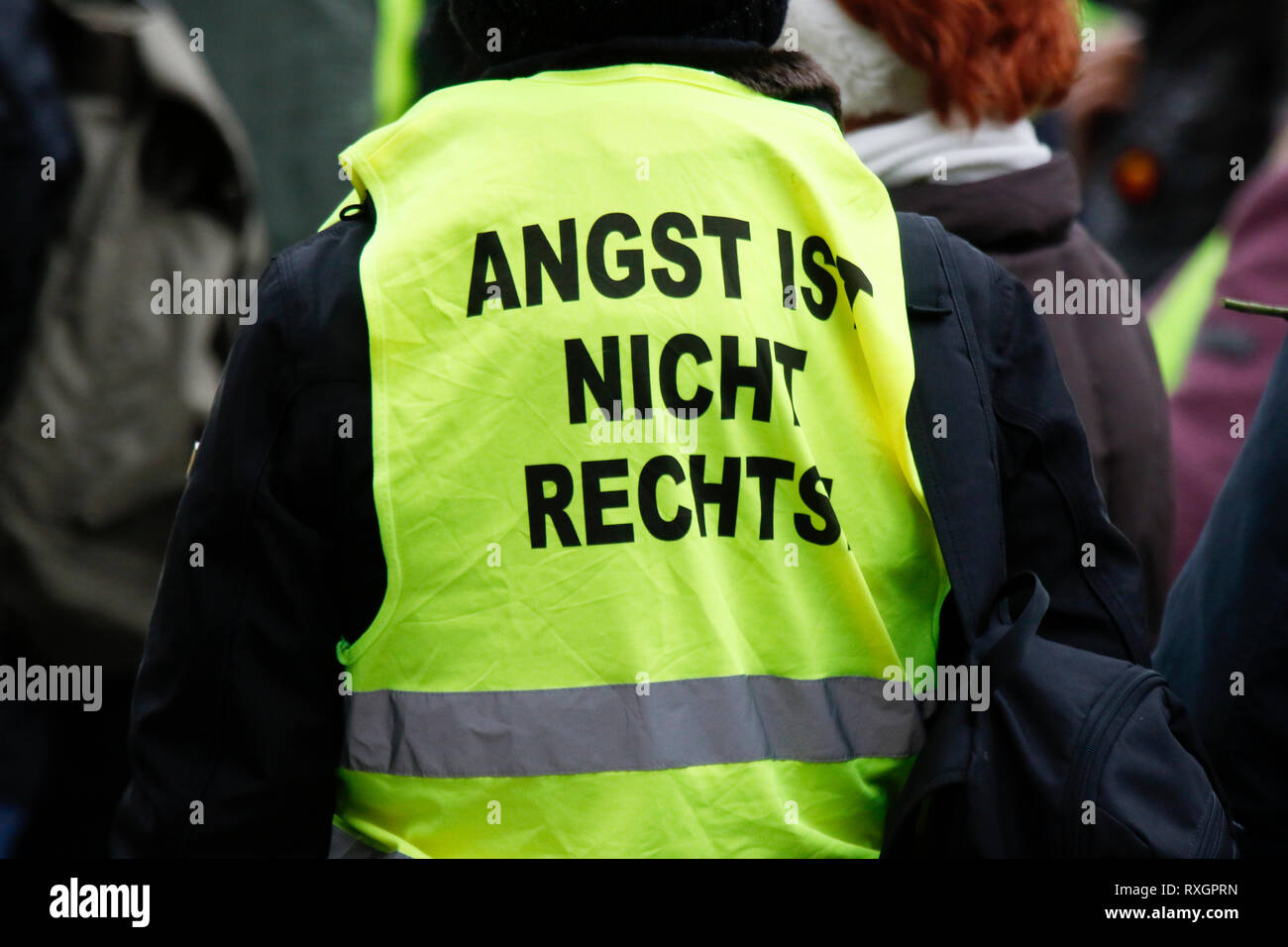 Landau, Germany. 9th March 2019. A protester wears a yellow vest with 'Fear is not right wing' written on it. Around 80 people from right-wing organisations protested in the city of Landau in Palatinate against the German government and migrants. They also adopted the yellow vests from the French yellow vest protest movement. The place of the protest was chosen because of the 2017 stabbing attack in the nearby city of Kandel, in which a 15 year old girl was killed by an asylum seeker. Credit: Michael Debets/Alamy Live News Stock Photo