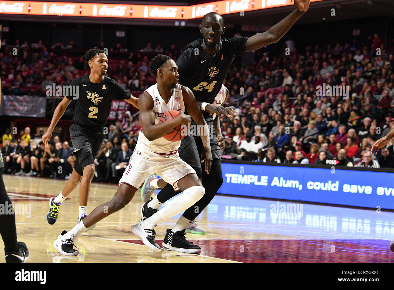 Philadelphia, Pennsylvania, USA. 9th Mar, 2019. Temple Owls guard SHIZZ ALSTON JR. (10) drives as he is defended by UCF Knights center TACKO FALL (24) during the American Athletic Conference basketball game played at the Liacouras Center in Philadelphia. Temple beat #25 UCF 67-62. Credit: Ken Inness/ZUMA Wire/Alamy Live News Stock Photo
