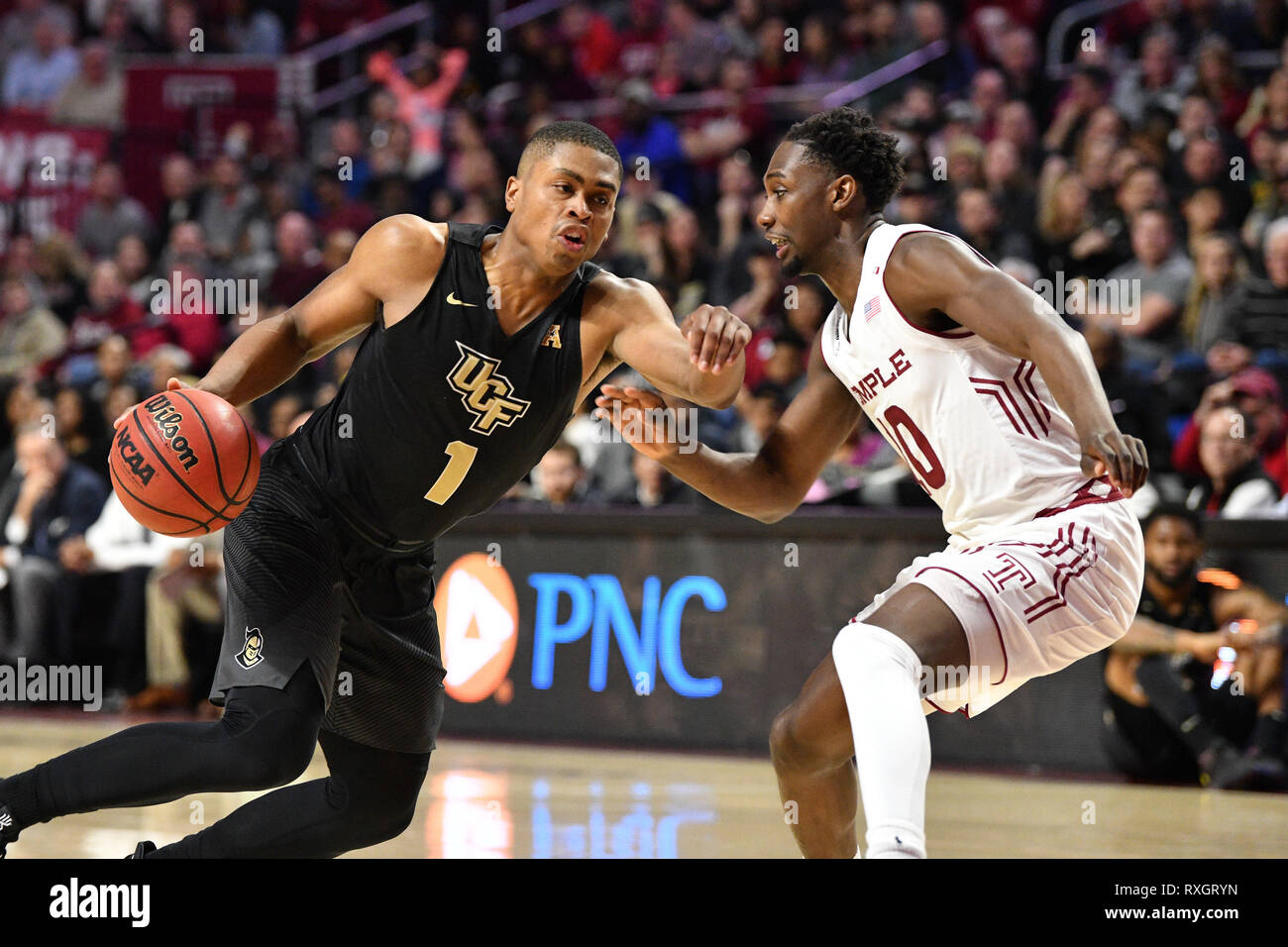 Philadelphia, Pennsylvania, USA. 9th Mar, 2019. UCF Knights guard B.J. TAYLOR (1) tries to drive by Temple Owls guard SHIZZ ALSTON JR. (10) during the American Athletic Conference basketball game played at the Liacouras Center in Philadelphia. Temple beat #25 UCF 67-62. Credit: Ken Inness/ZUMA Wire/Alamy Live News Stock Photo