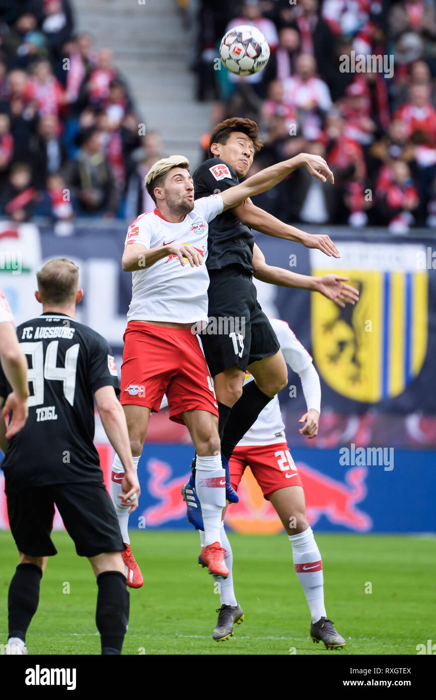 Leipzig, Germany. 9th Mar, 2019. Leipzig's Kevin Kampl (top, L) vies for header with Augsburg's Koo Ja-Cheol (top, R) during a German Bundesliga match between RB Leipzig and FC Augsburg, in Leipzig, Germany, on March 9, 2019. The match ended with a 0-0 draw. Credit: Kevin Voigt/Xinhua/Alamy Live News Stock Photo