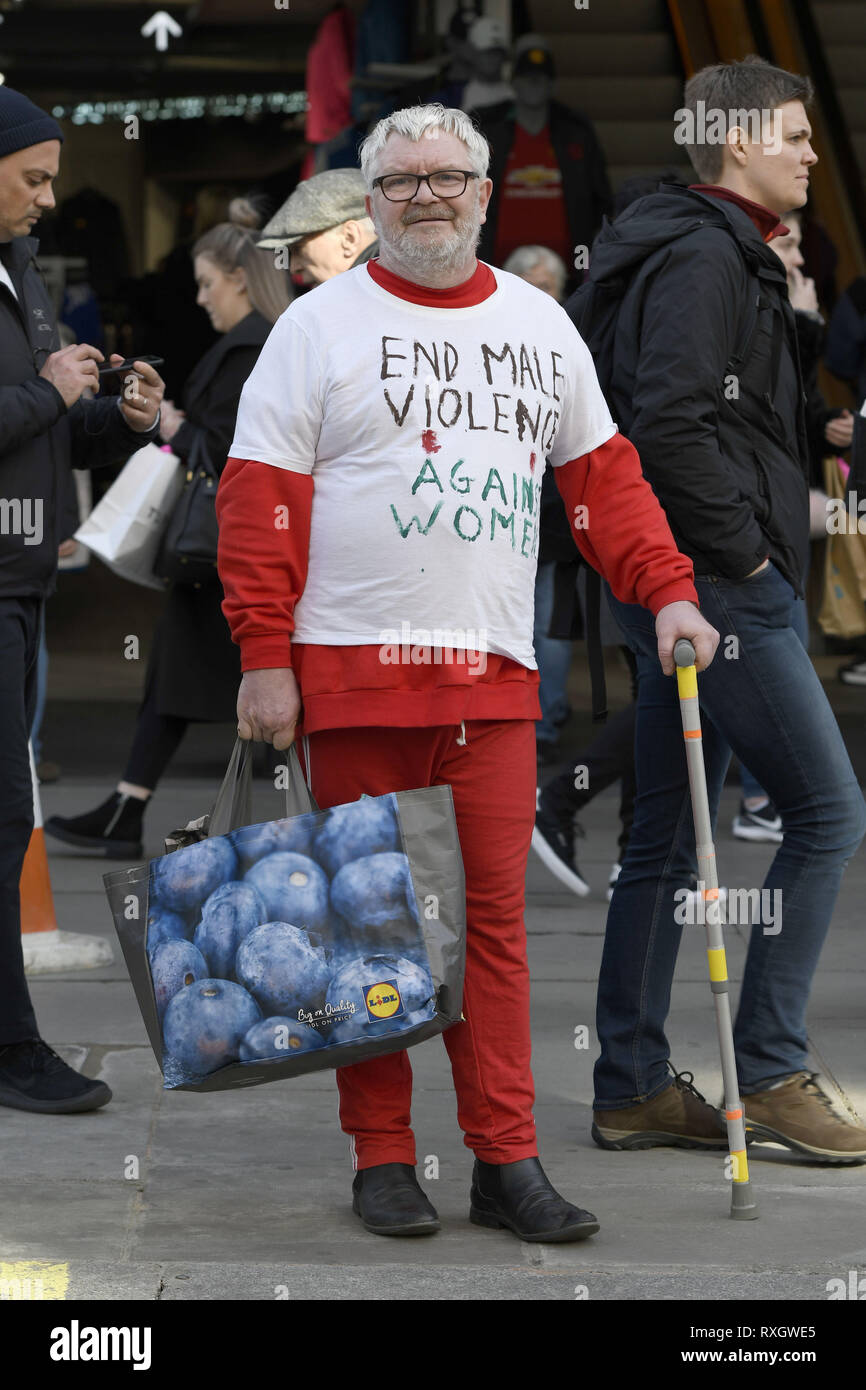London, Greater London, UK. 9th Mar, 2019. A man seen wearing a T-shirt reading 'End male violence against women'' in support of the Million women's rise march.Thousands of women marched through central London to a rally in Trafalgar Square in London demanding freedom and justice and the end of male violence against them. ''˜Never Forgotten' was the theme for this year's march and participants commemorated the lives of girls and women who have been killed by mens's violence. Credit: Andres Pantoja/SOPA Images/ZUMA Wire/Alamy Live News Stock Photo