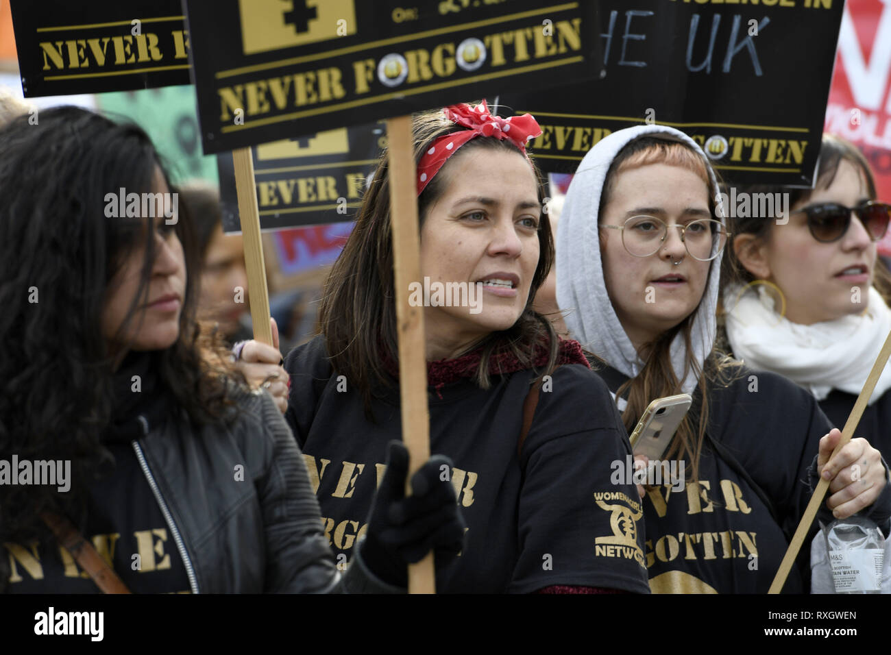 London, Greater London, UK. 9th Mar, 2019. Women seen holding placards during the Million Women's Rise march in London.Thousands of women marched through central London to a rally in Trafalgar Square in London demanding freedom and justice and the end of male violence against them. ''˜Never Forgotten' was the theme for this year's march and participants commemorated the lives of girls and women who have been killed by mens's violence. Credit: Andres Pantoja/SOPA Images/ZUMA Wire/Alamy Live News Stock Photo