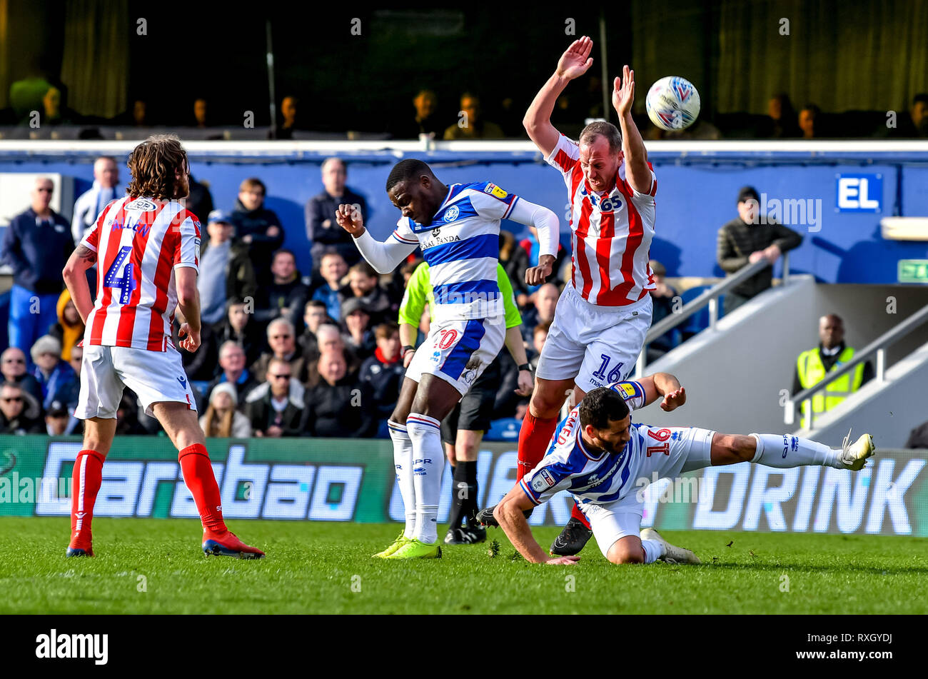 London, UK. 9th March 2019. Tomer Hemed, Bright Osayi-Samuel of Queens Park Rangers and Charlie Adam of Stoke City clash during the EFL Sky Bet Championship match between Queens Park Rangers and Stoke City at the Loftus Road Stadium, London, England on 9 March 2019. Photo by Phil Hutchinson.  Editorial use only, license required for commercial use. No use in betting, games or a single club/league/player publications. Credit: UK Sports Pics Ltd/Alamy Live News Stock Photo