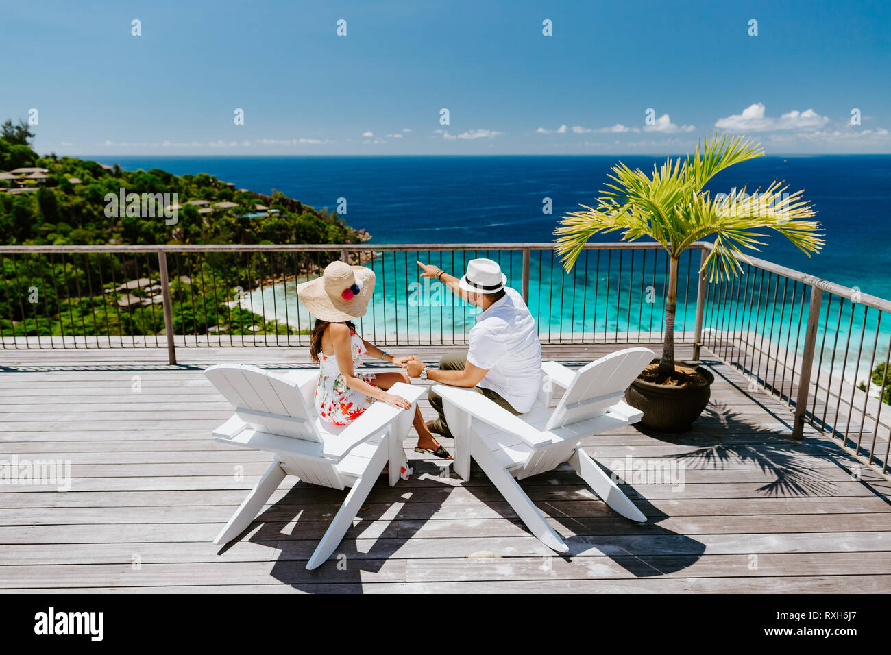 luxury couple relax on beach resort in tropics. Honeymoon couple travel in tropics in hot summer Stock Photo