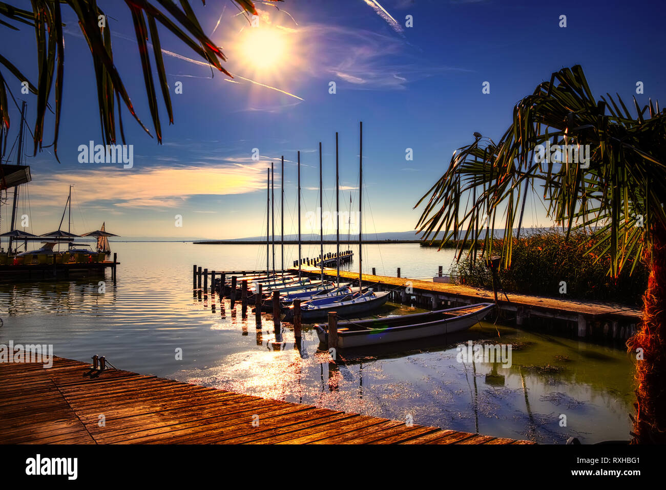Small harbour at Lake Neusiedl in Austria with Boats and sailing ships. Neusiedl am See is located on the northern shore of the Neusiedler See. Stock Photo