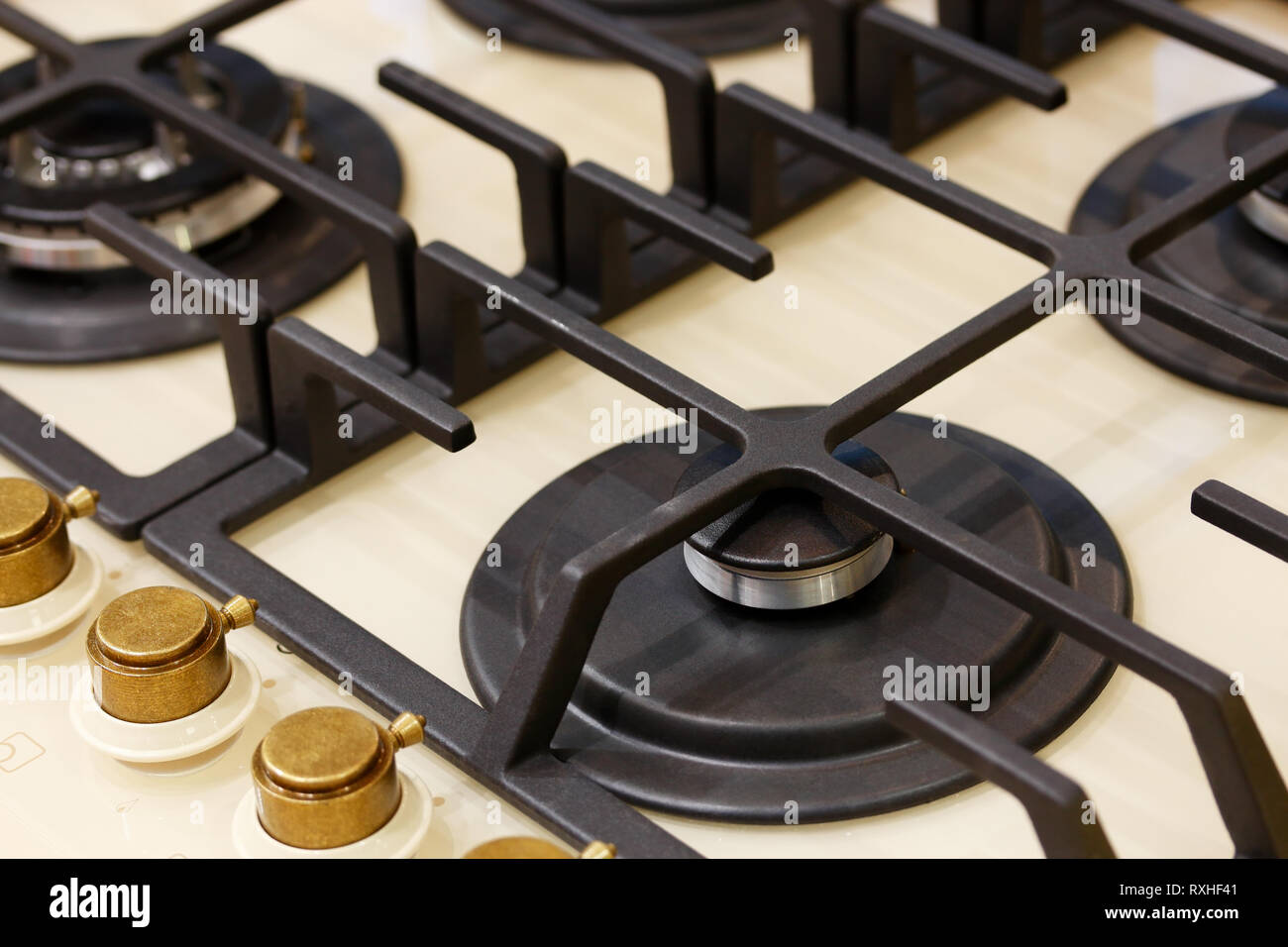 Classic four burner gas stove with brass knobs. Selective focus. Stock Photo