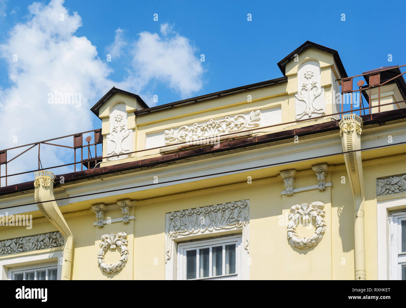 Stucco molding and decorative elements on the old historical facade of the building Stock Photo