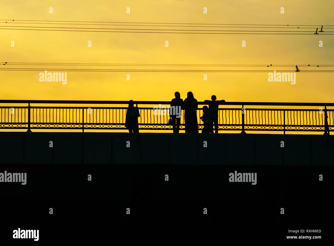 Silhouettes a Group of People on the High Bridge on a Background of ...