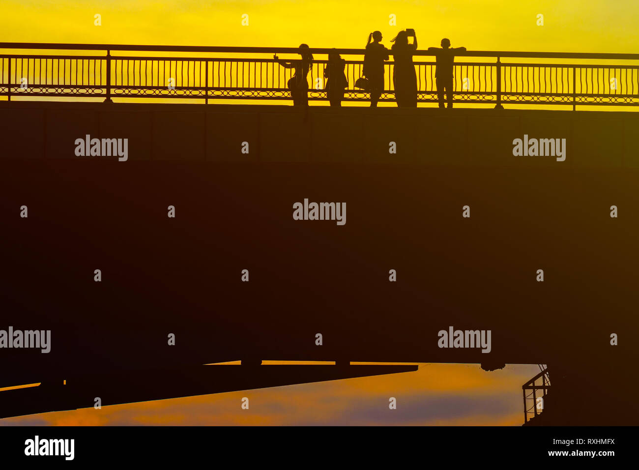 Silhouettes a Group of People on the High Bridge on a Background of ...