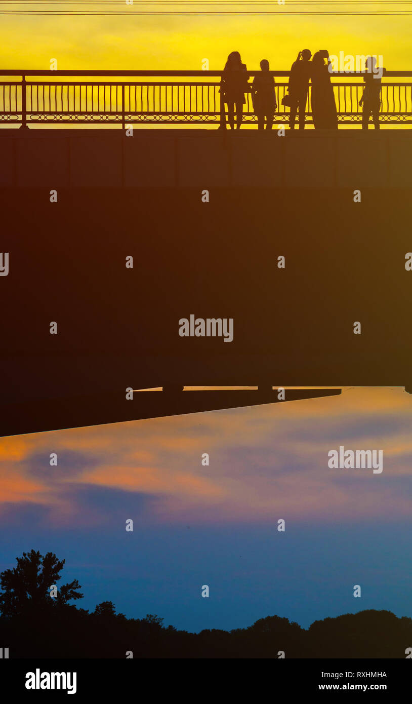 Silhouettes a Group of People on the High Bridge on a Background of ...