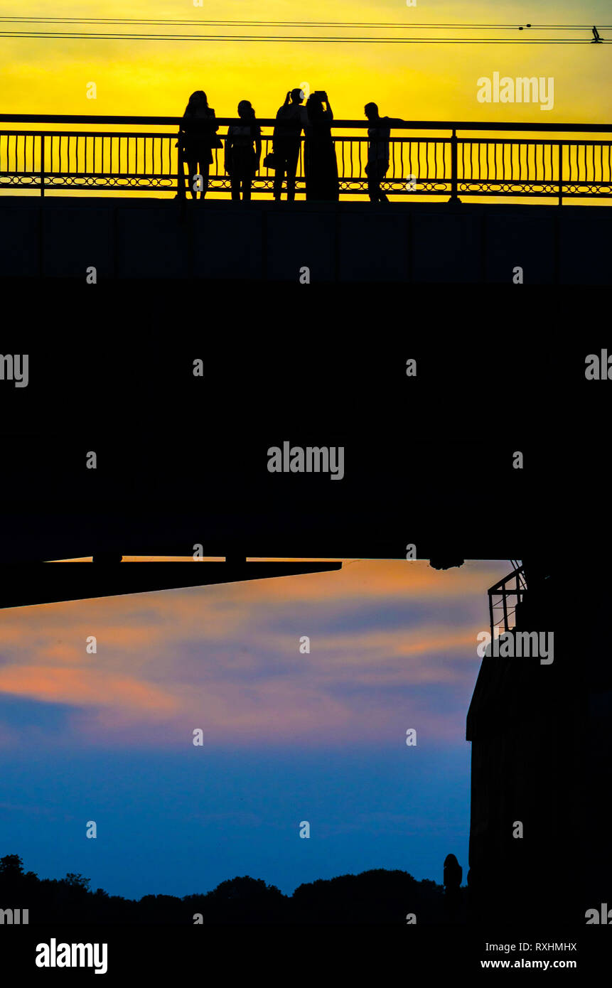 Silhouettes a Group of People on the High Bridge on a Background of ...
