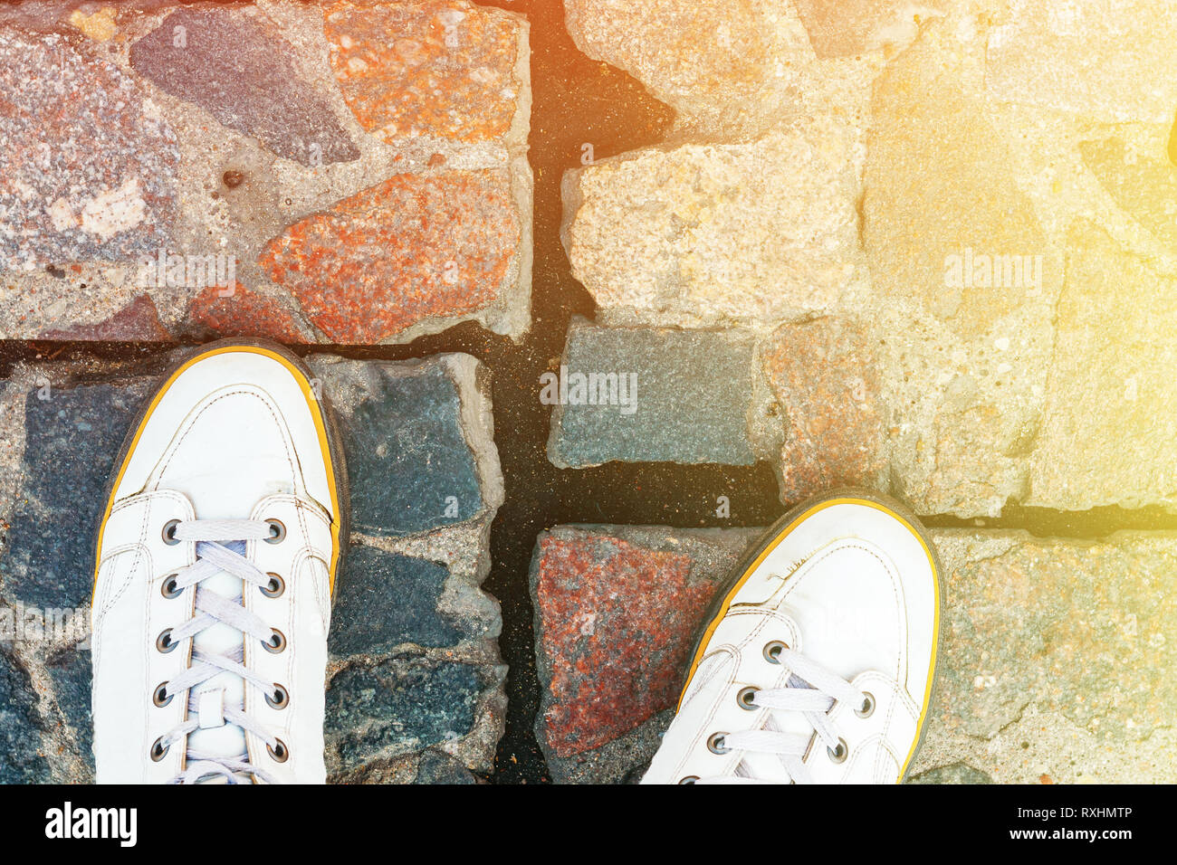 White Leather Sneakers on Granite Pavement Background Top View. Copy Space Stock Photo