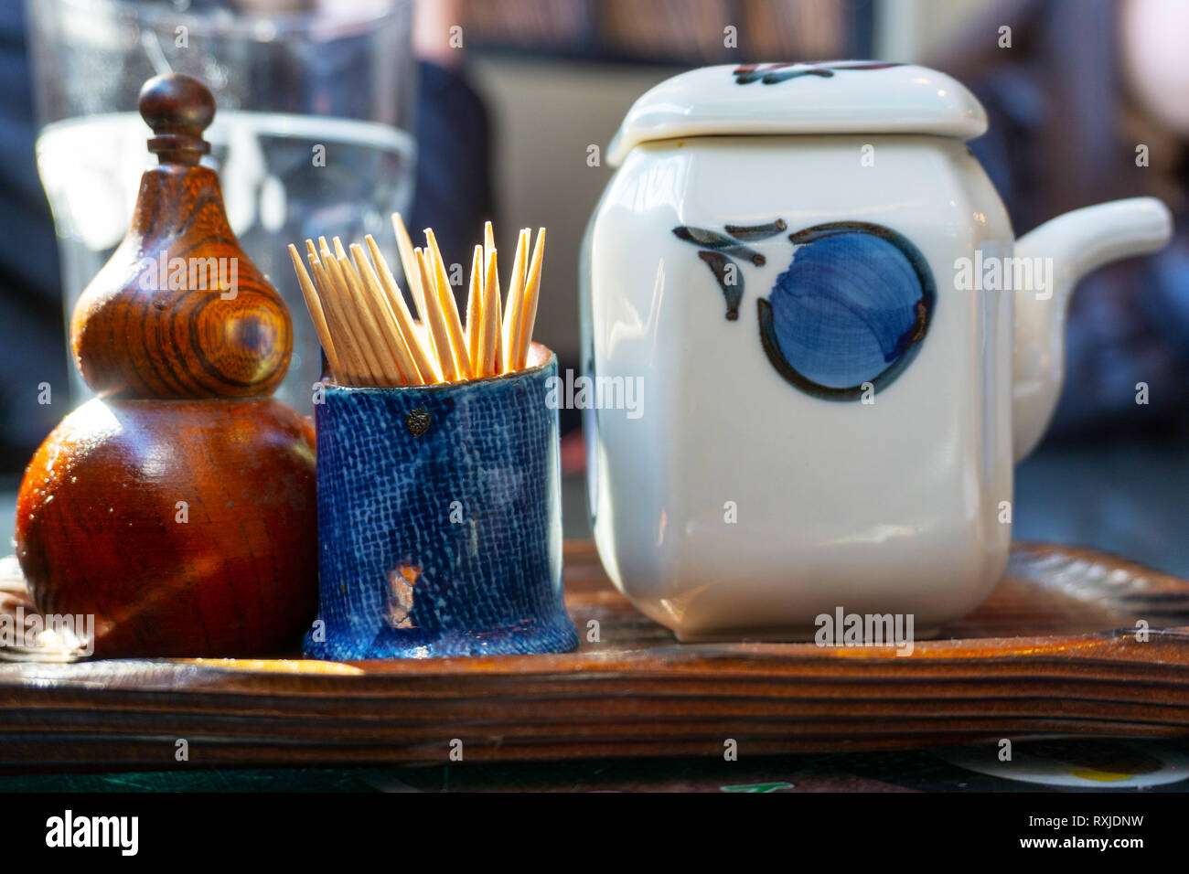 Restaurant condiment tray for Japanese food consisting of Soy Sauce, toothpicks and seasoning salt and pepper. Stock Photo