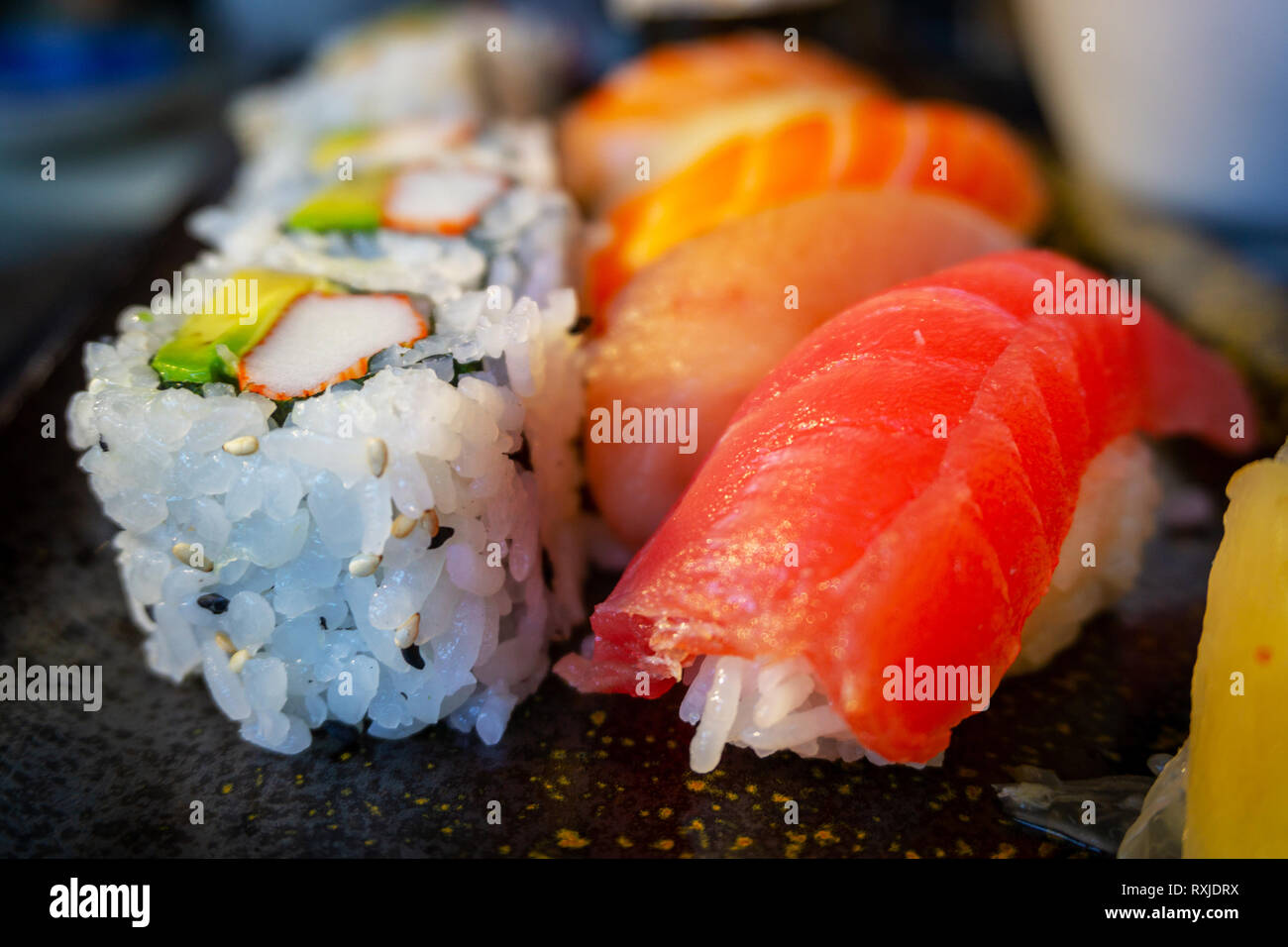 Delicious Japanese nigiri sushi bento with Tuna Toro, Tuna Ahi, Salmon Sake, Yellowtail Hamachi, Shrimp Ebi, and California roll. Stock Photo