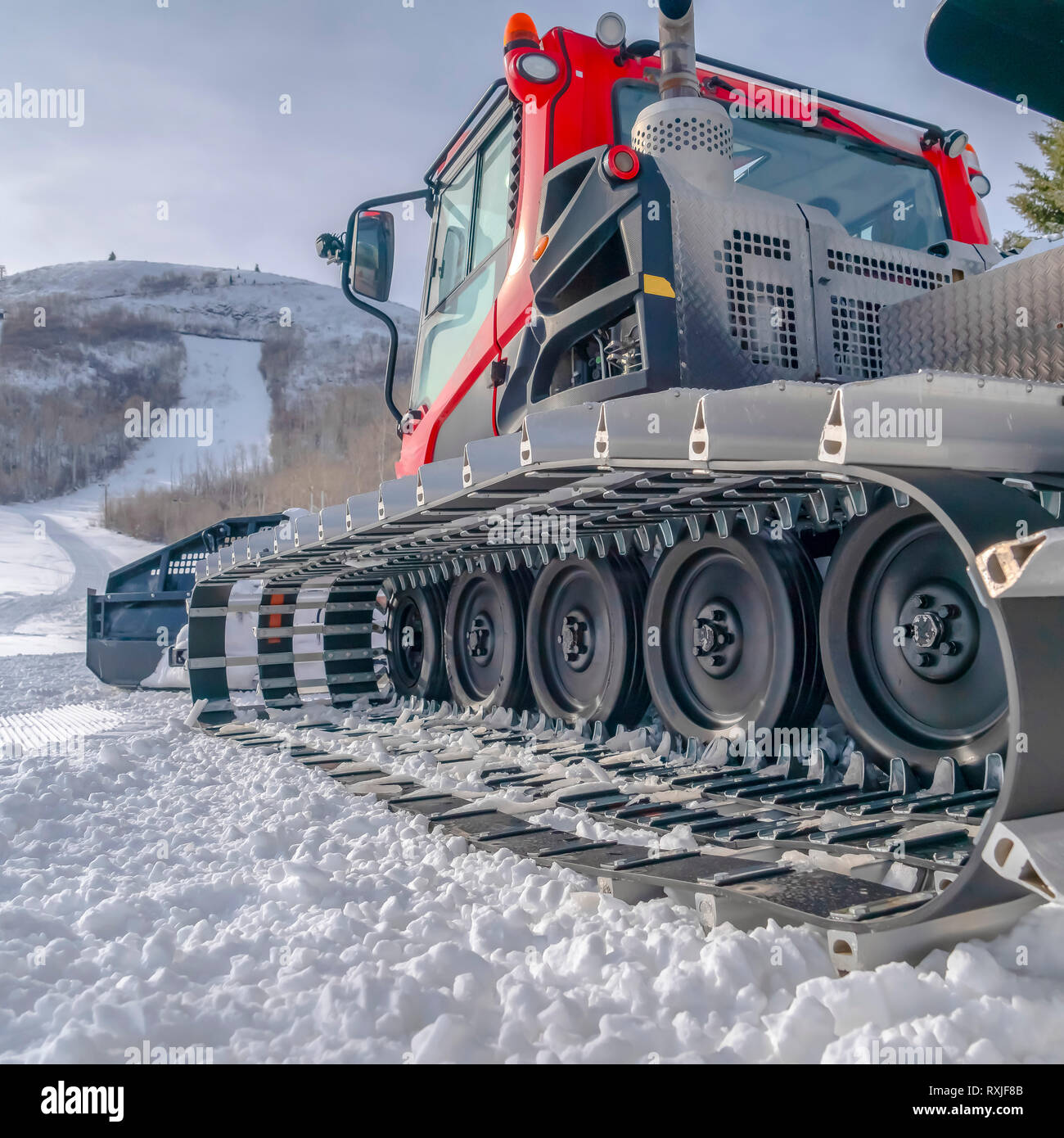 Snow grooming machine against the snowy ski slope Stock Photo Alamy