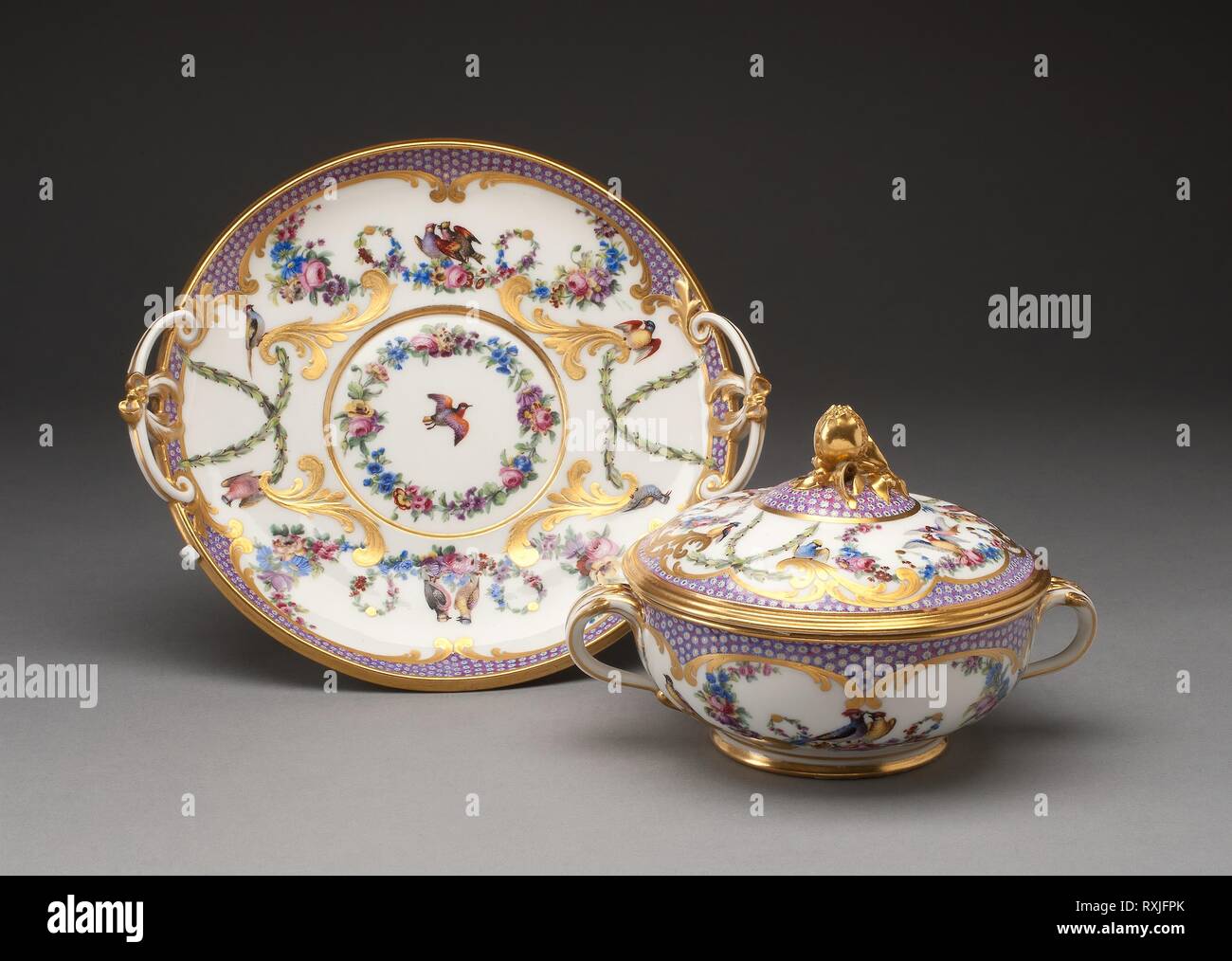 Covered Bowl and Stand (Écuelle). Sèvres Porcelain Manufactory; French, founded 1740; Painted by Jean-Jacques Pierre (French, active 1763-1800); Gilded by Henri-Martin Prévost III (French, active 1757-1797). Date: 1779. Dimensions: Overall H. 12.7 cm (5 in.); Stand: 4.5 x 23.9 x 21.6 cm (1 3/4 x 9 3/8 x 8 1/2 in.); Bowl: 11.4 x 18.1 x 14.3 cm (4 1/2 x 7 1/8 x 5 5/8 in.). Soft-paste porcelain, polychrome enamels, and gilding. Origin: Sèvres. Museum: The Chicago Art Institute. Author: Manufacture nationale de Sevres. Stock Photo