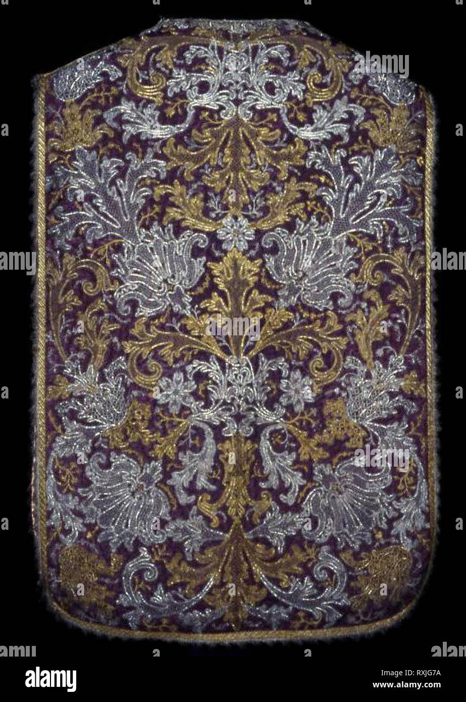 Chasuble. Italy, probably Turin. Date: 1710-1730. Dimensions: 100.4 x 68.6 cm (41 x 27 in.). Silk, warp-faced weft-ribbed plain weave; underlaid with linen, plain weave; appliquéd with gilt- and silvered-metal strips and metal-strip-wrapped silk, bobbin part lace; embroidered with silk, gilt- and silvered-metal strips and wire coils, and metal-strip-wrapped silk in laid work, couching, and padded couching; edged with silvered-metal-strip-wrapped silk, warp-faced weft-ribbed plain weave with extended weft uncut fringe, and bobbin straight lace; lined with silk, plain weave. Origin: Italy. Museu Stock Photo