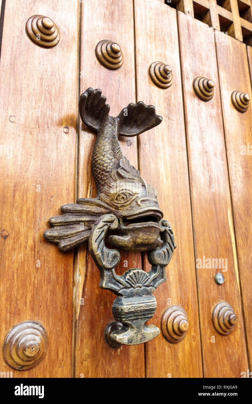 Cartagena Colombia,metal door knocker,fancy ornate doorknocker,aldaba,sea creature,fish,bronze,COL190119184 Stock Photo