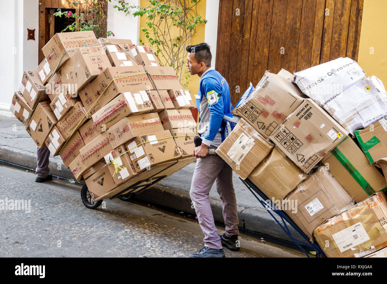 Cartagena Colombia,Hispanic resident residents,man men male,working hauling cardboard boxes rolling cart manual labor,delivery,man men male,COL1901191 Stock Photo