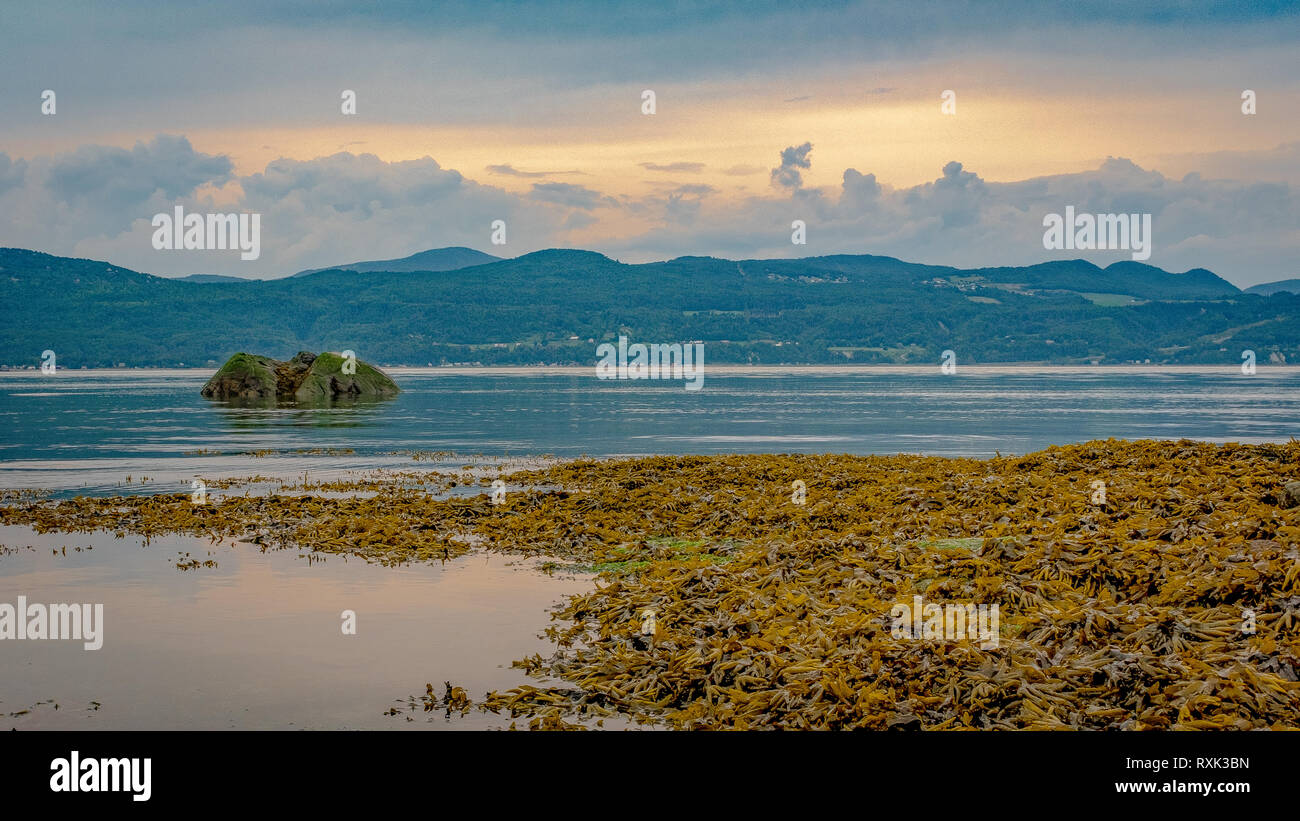 Evening light on St.Lawrence river, looking at the Charlevoix hills from Aux Coudres Island, province of Quebec, Canada Stock Photo