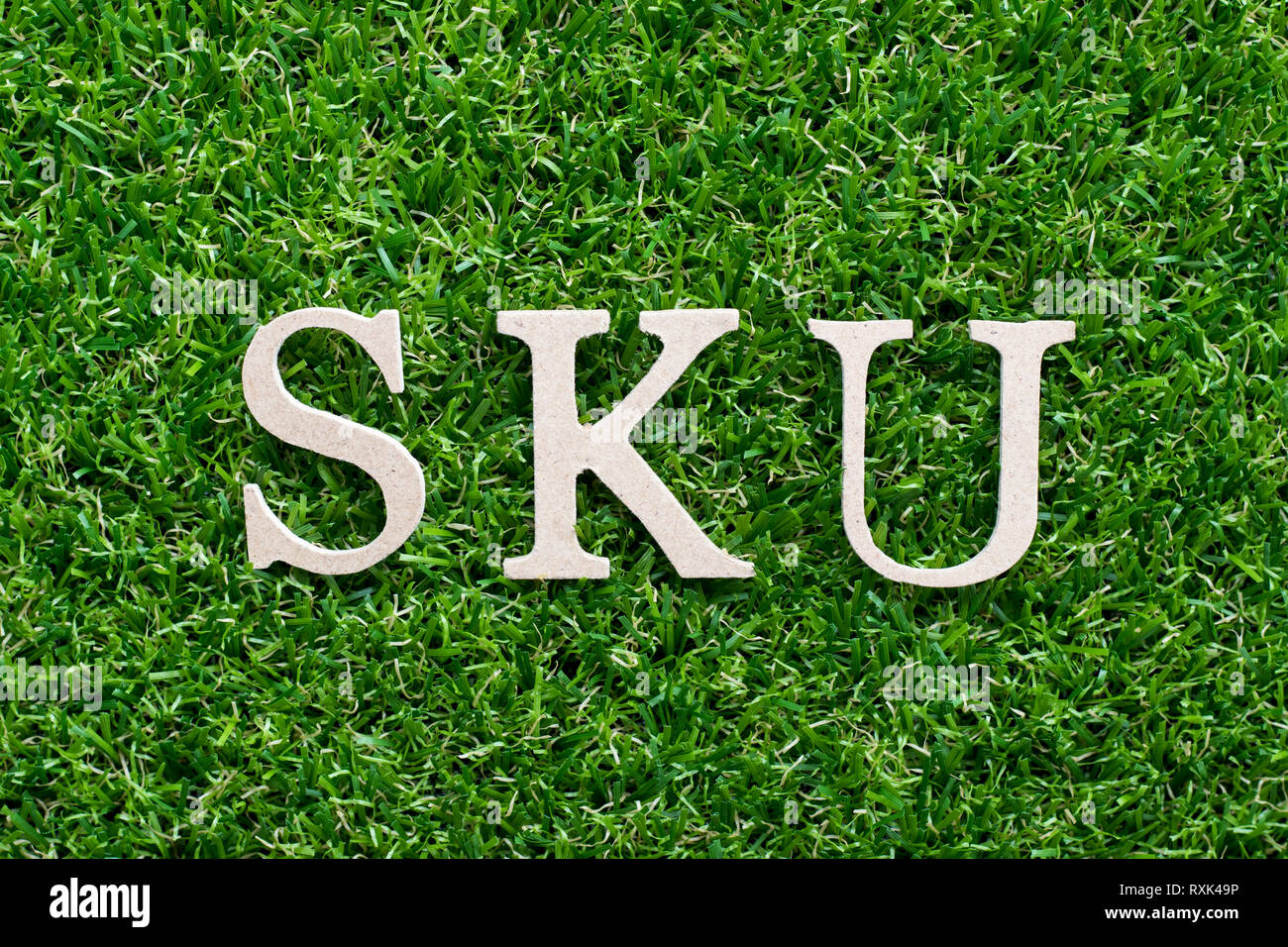 Wood alphabet in word SKU (abbreviation of stock keeping unit) on