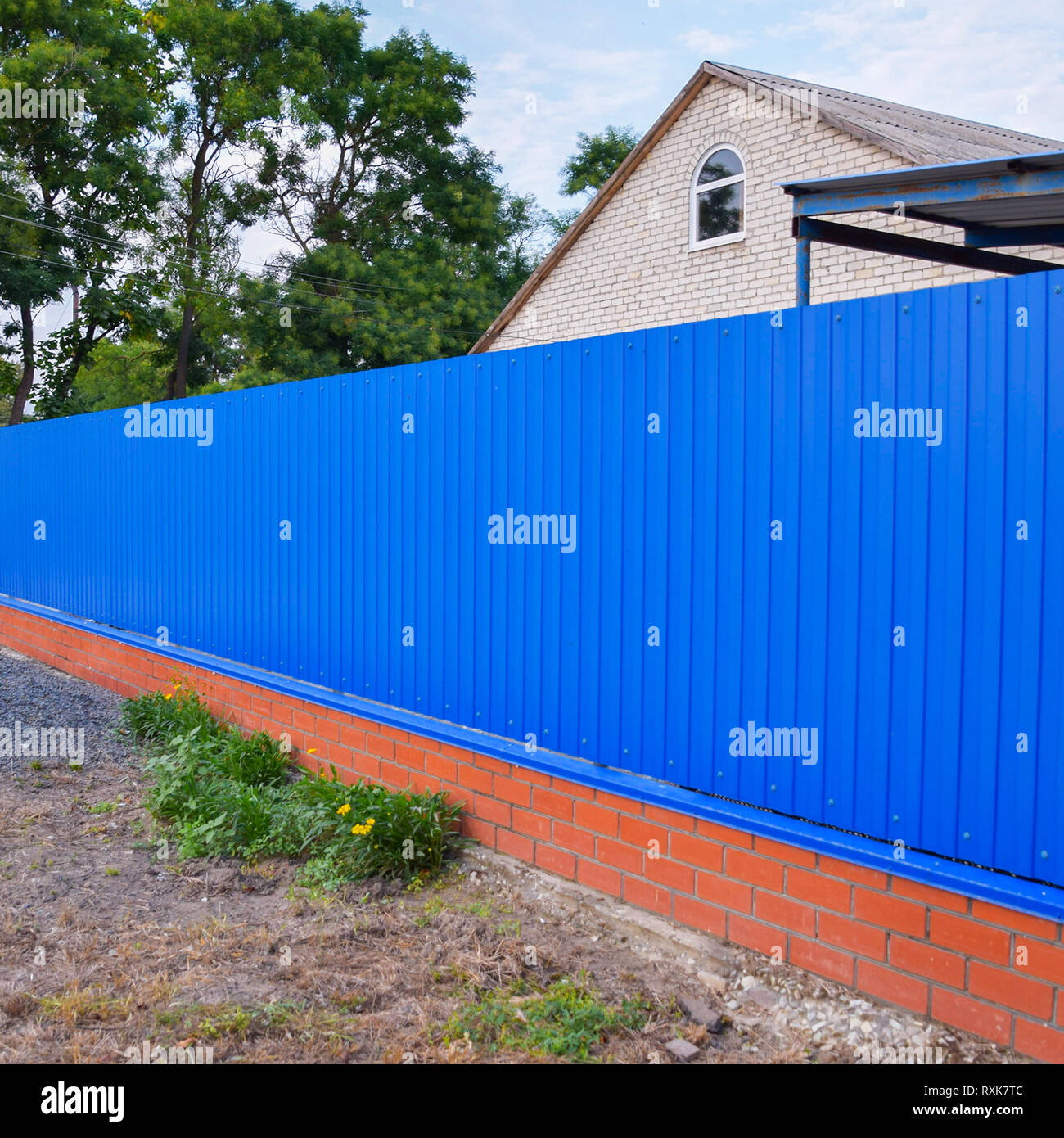 Blue gate and fence. Fence of the private house with blue fence and a